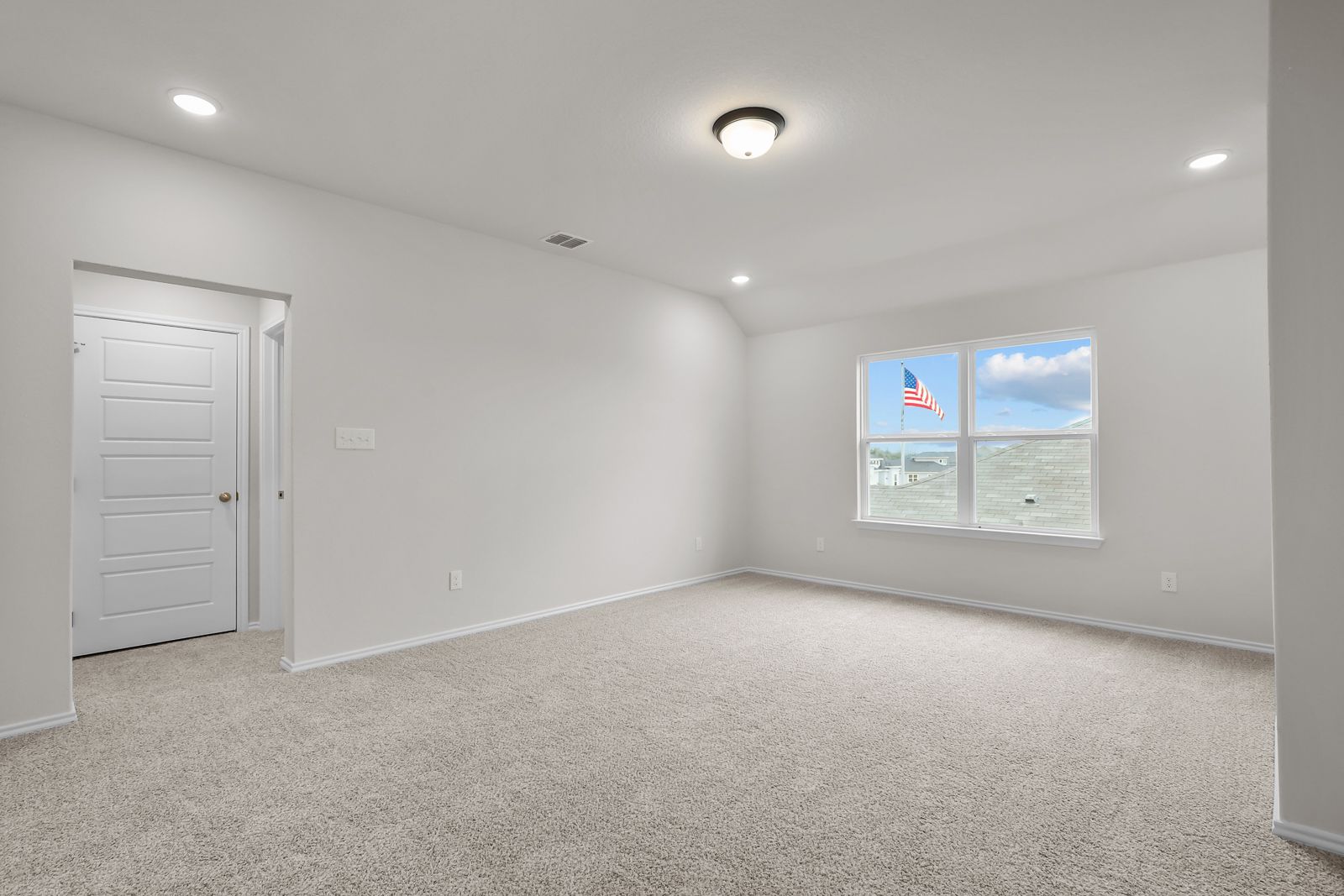 Spacious bedroom interior in The Sequoia C featuring neutral carpeting, recessed lighting, and large windows.