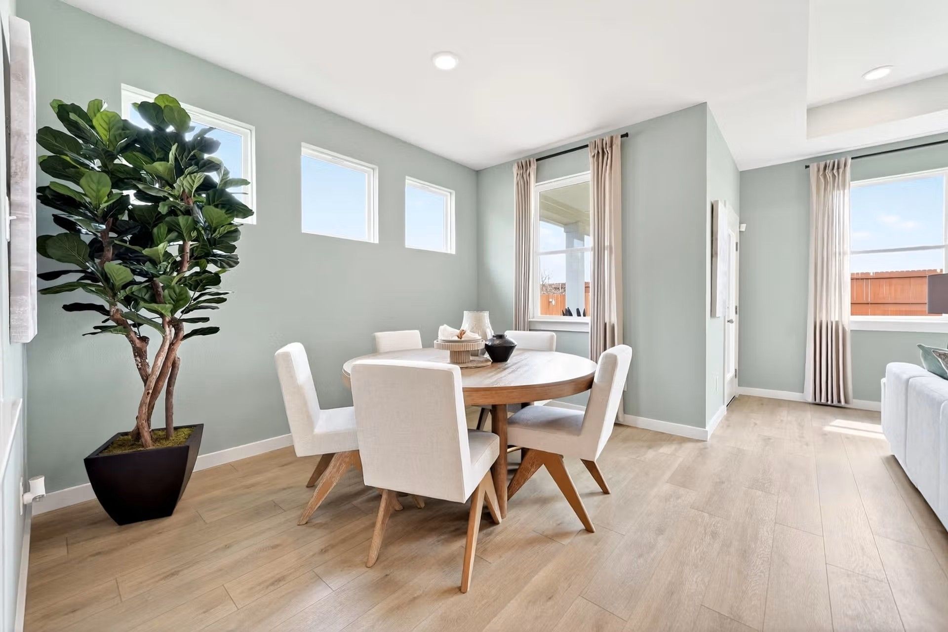 Bright dining area with round wood table and chairs in The Laurel I floor plan by Davidson Homes in Heartland, Texas.