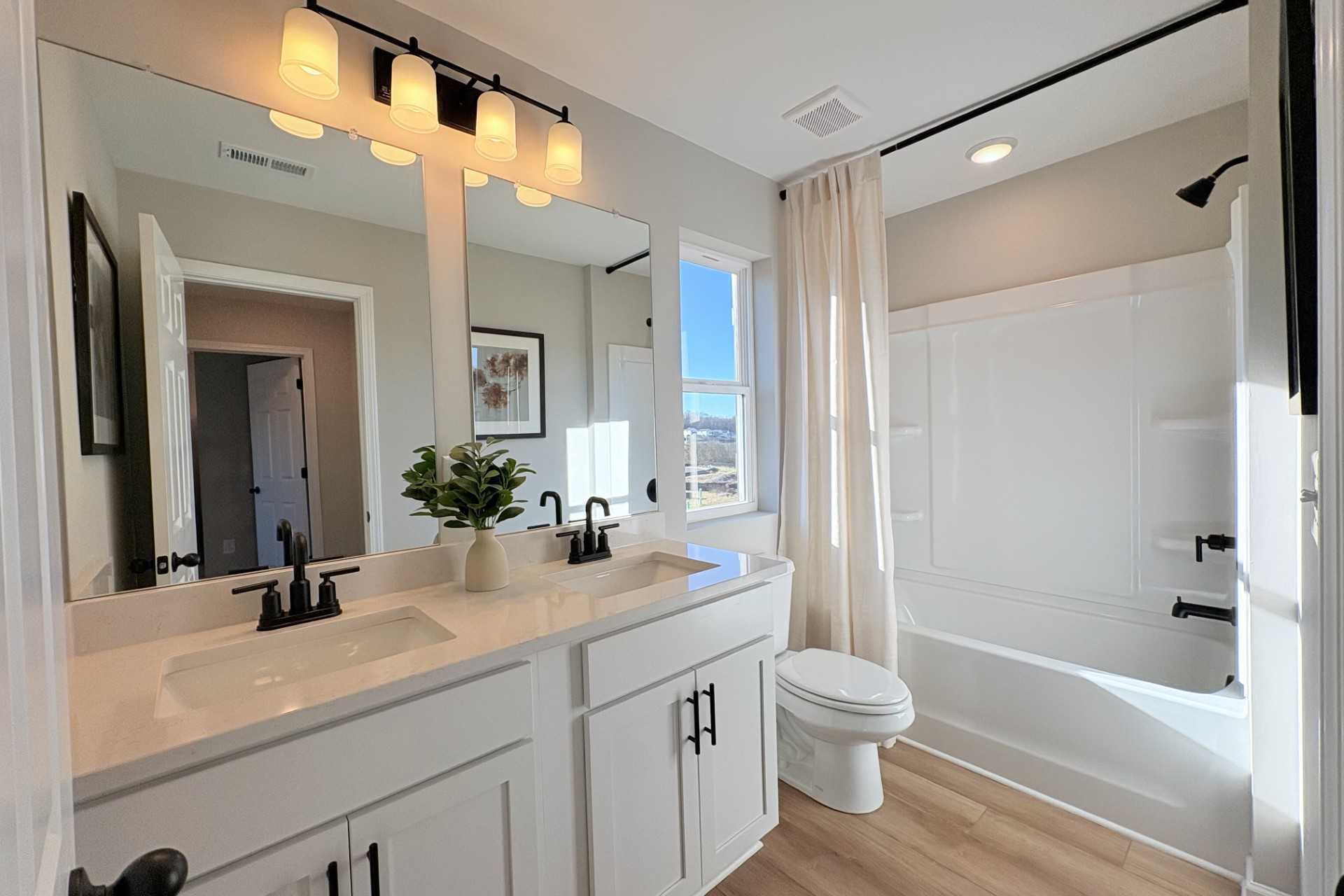 Luxurious primary bathroom in Hemingway community, Cumming GA with double vanity, freestanding tub, walk-in shower by Davidson Homes