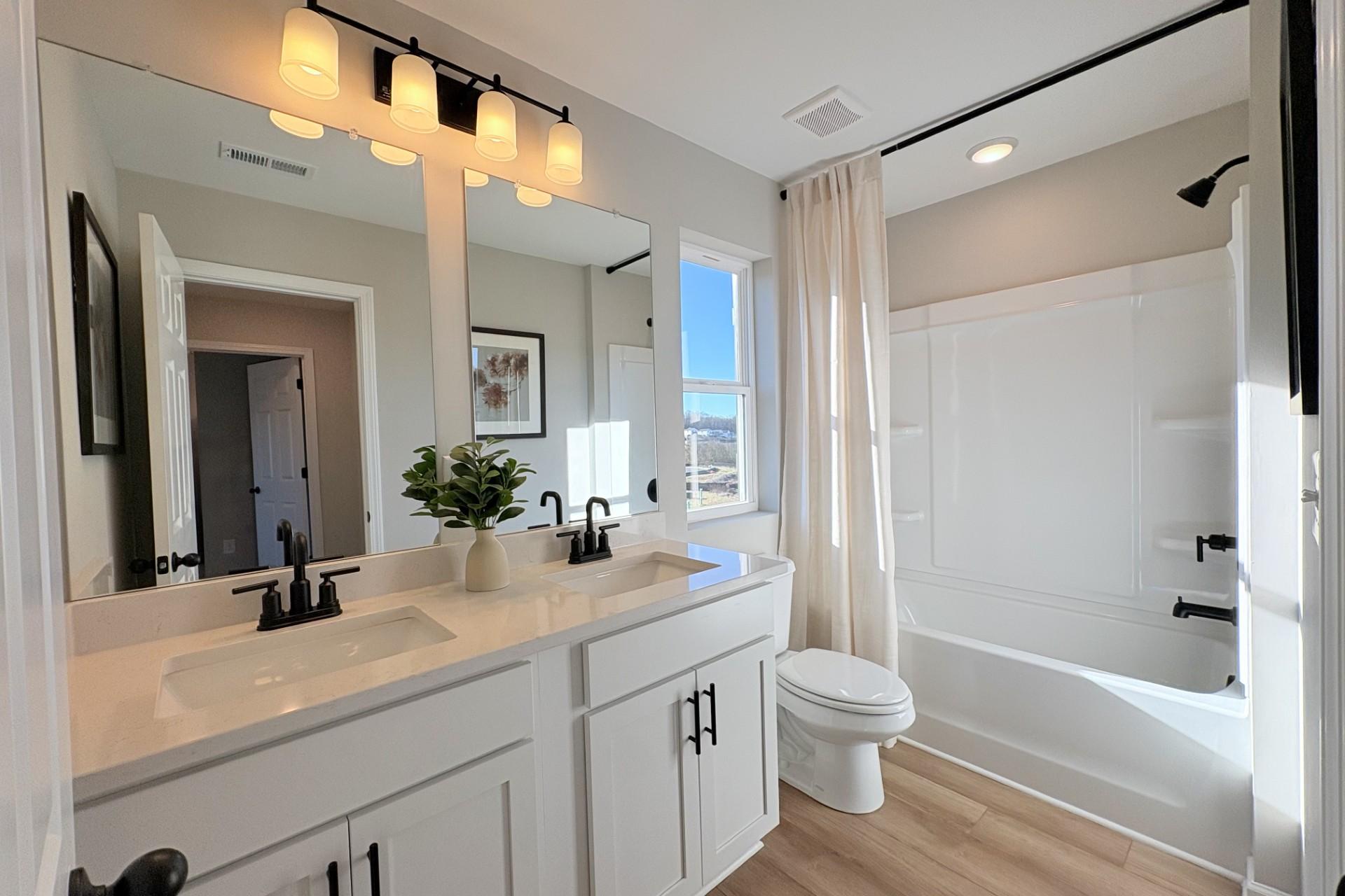 Luxurious primary bathroom in Hemingway community, Cumming GA with double vanity, freestanding tub, walk-in shower by Davidson Homes