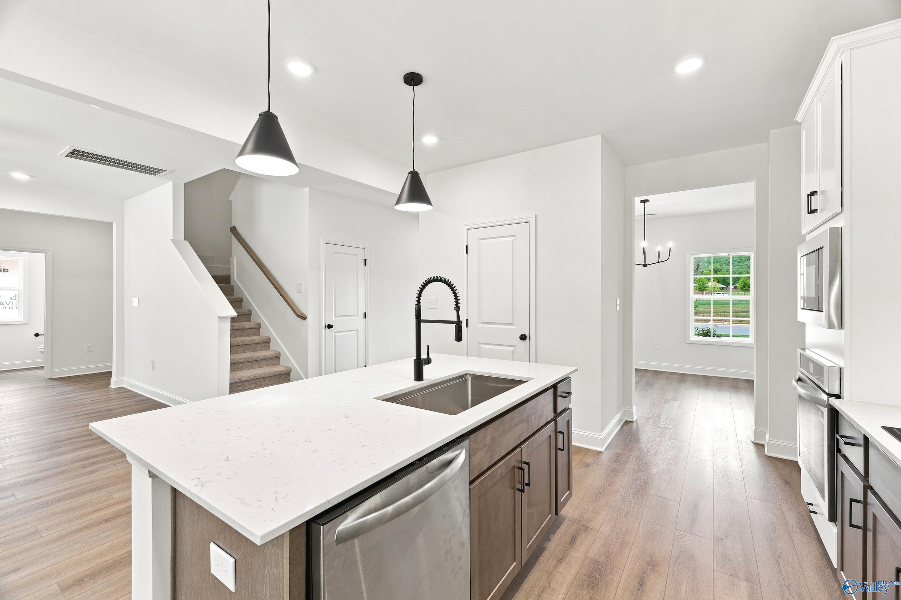Modern kitchen island with quartz countertops in The Shelby B floor plan by Davidson Homes, Jaguar Hills, Huntsville, AL.