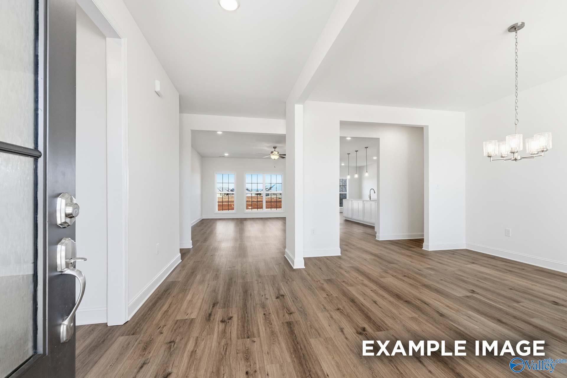Open-concept foyer and dining area with hardwood floors in The Valencia floor plan, Briercreek, Meridianville, Alabama.