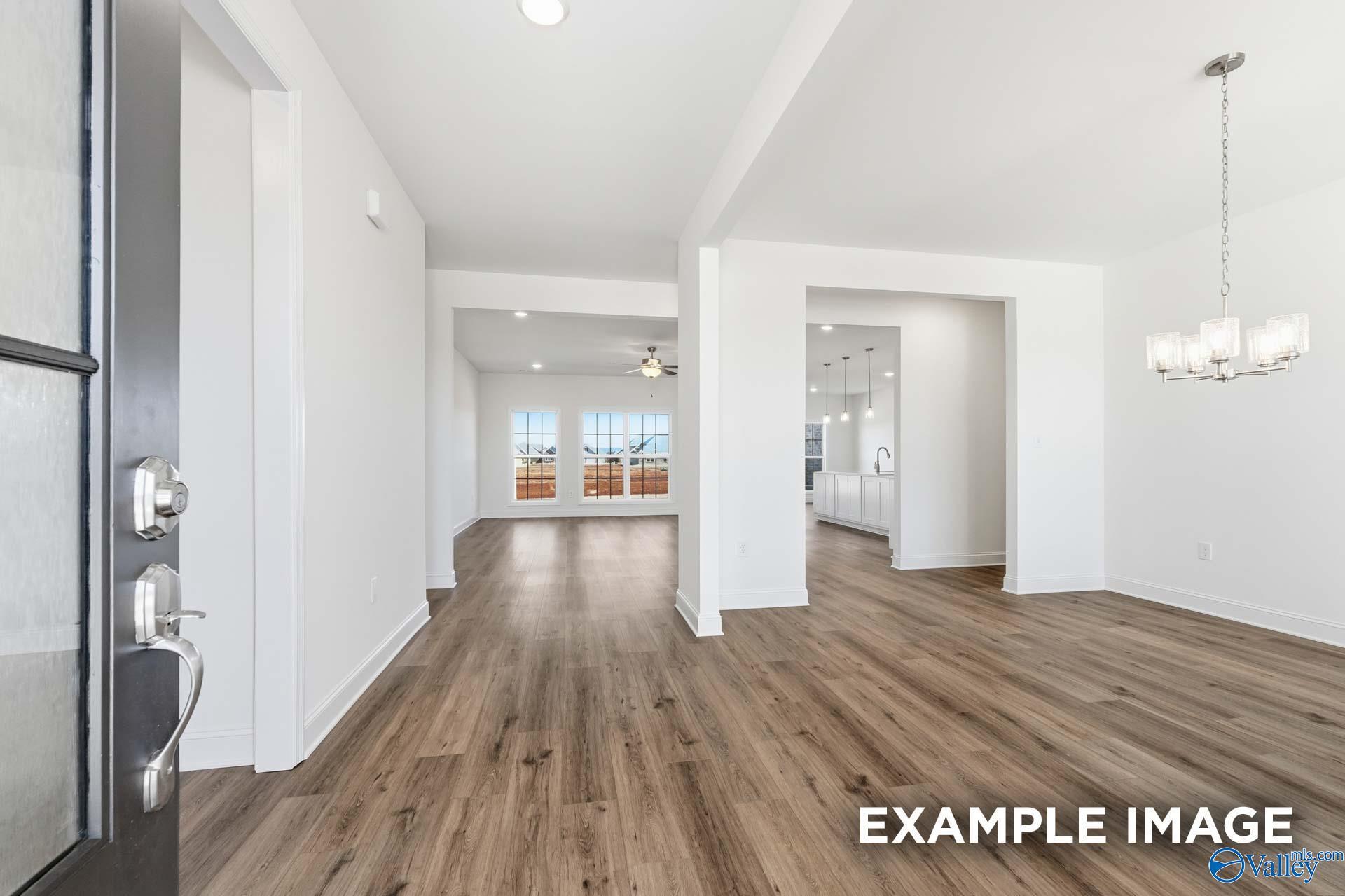 Open-concept foyer and dining area with hardwood floors in The Valencia floor plan, Briercreek, Meridianville, Alabama.