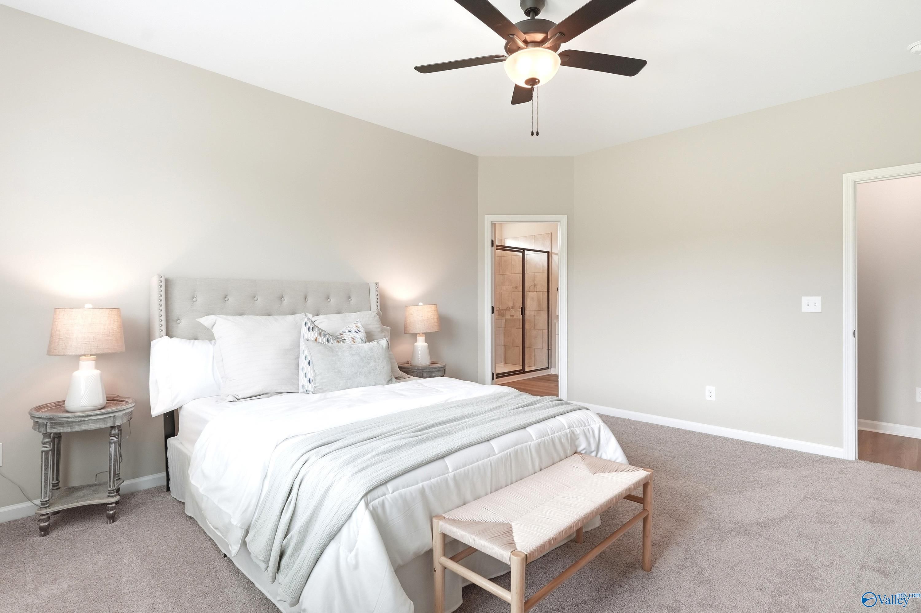 Bright primary bedroom with neutral decor and en-suite bathroom in The Dorado floor plan at Riverton Preserve, Huntsville.