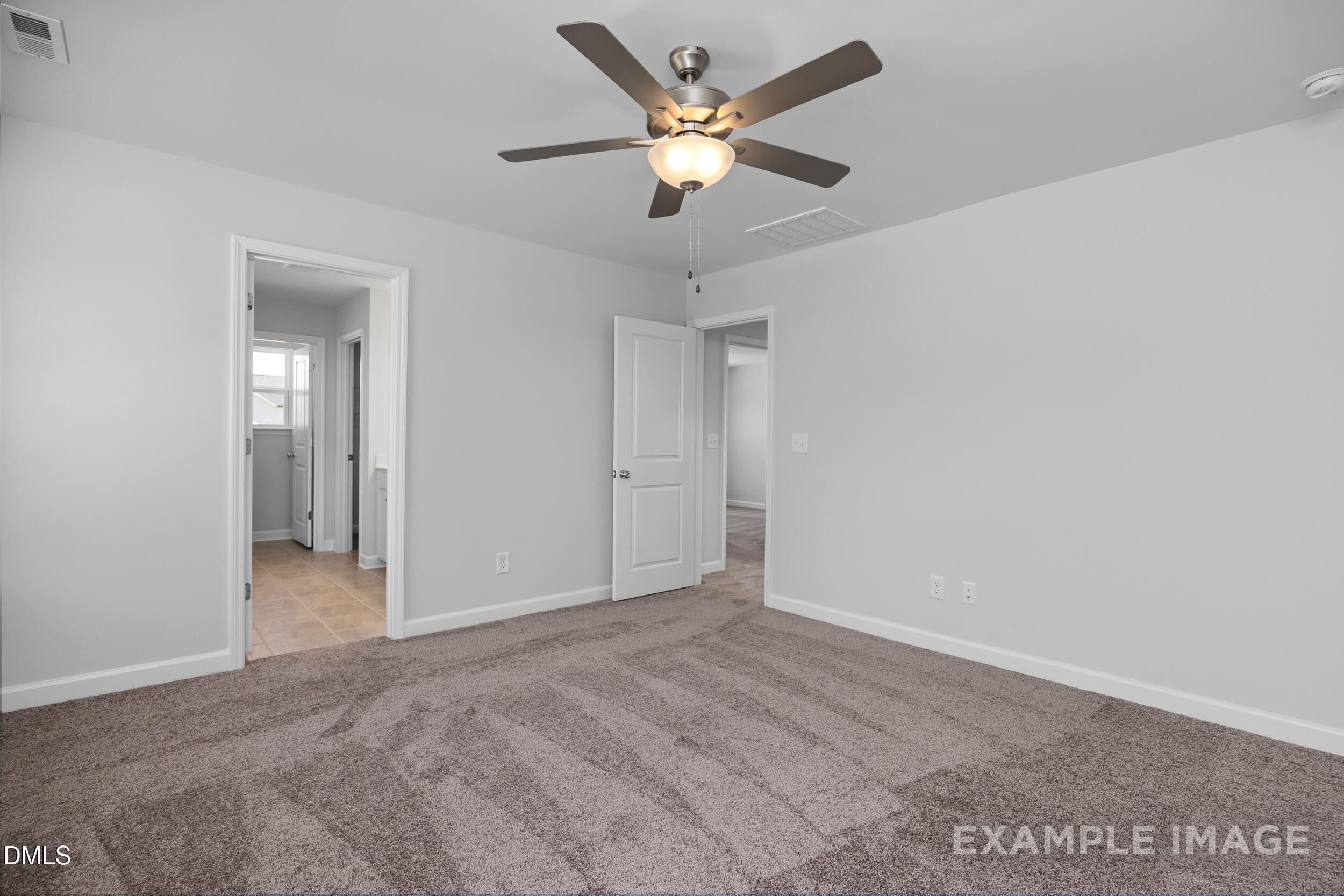Spacious carpeted bedroom with ceiling fan in The Gavin A floor plan by Davidson Homes in Gregory Village, Lillington, NC.
