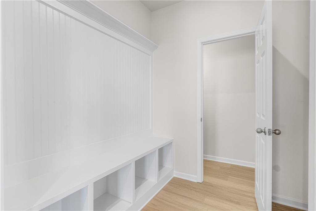 White mudroom bench with built-in storage cubbies in The Glenwood A floor plan at Wehunt Meadows, Hoschton, Georgia.