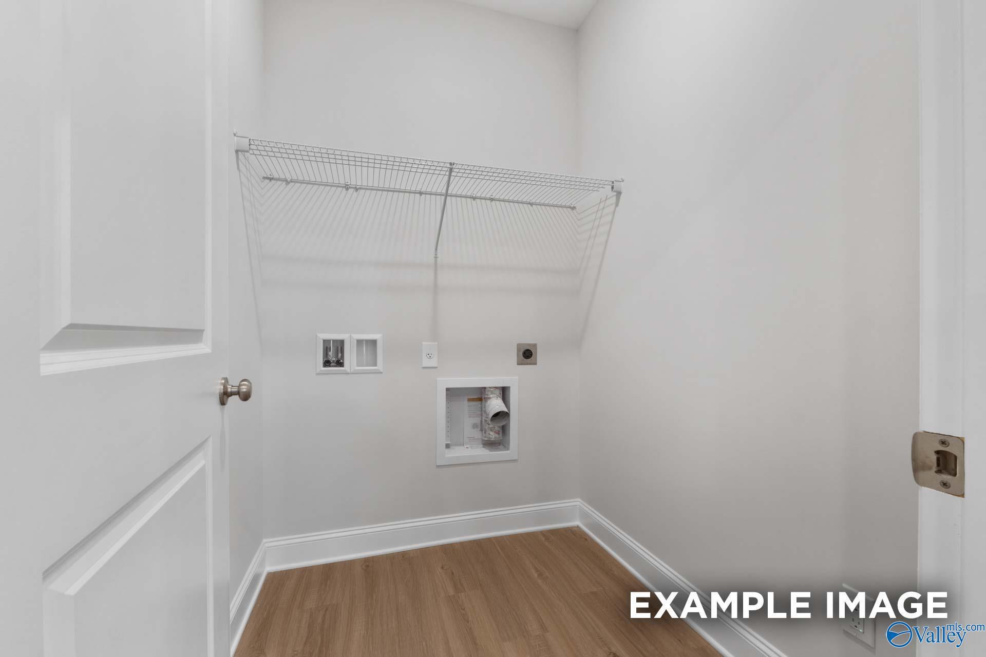 Functional laundry room with wire shelving, washer-dryer hookups in Davidson Homes The Camilla C, Hartselle, Alabama