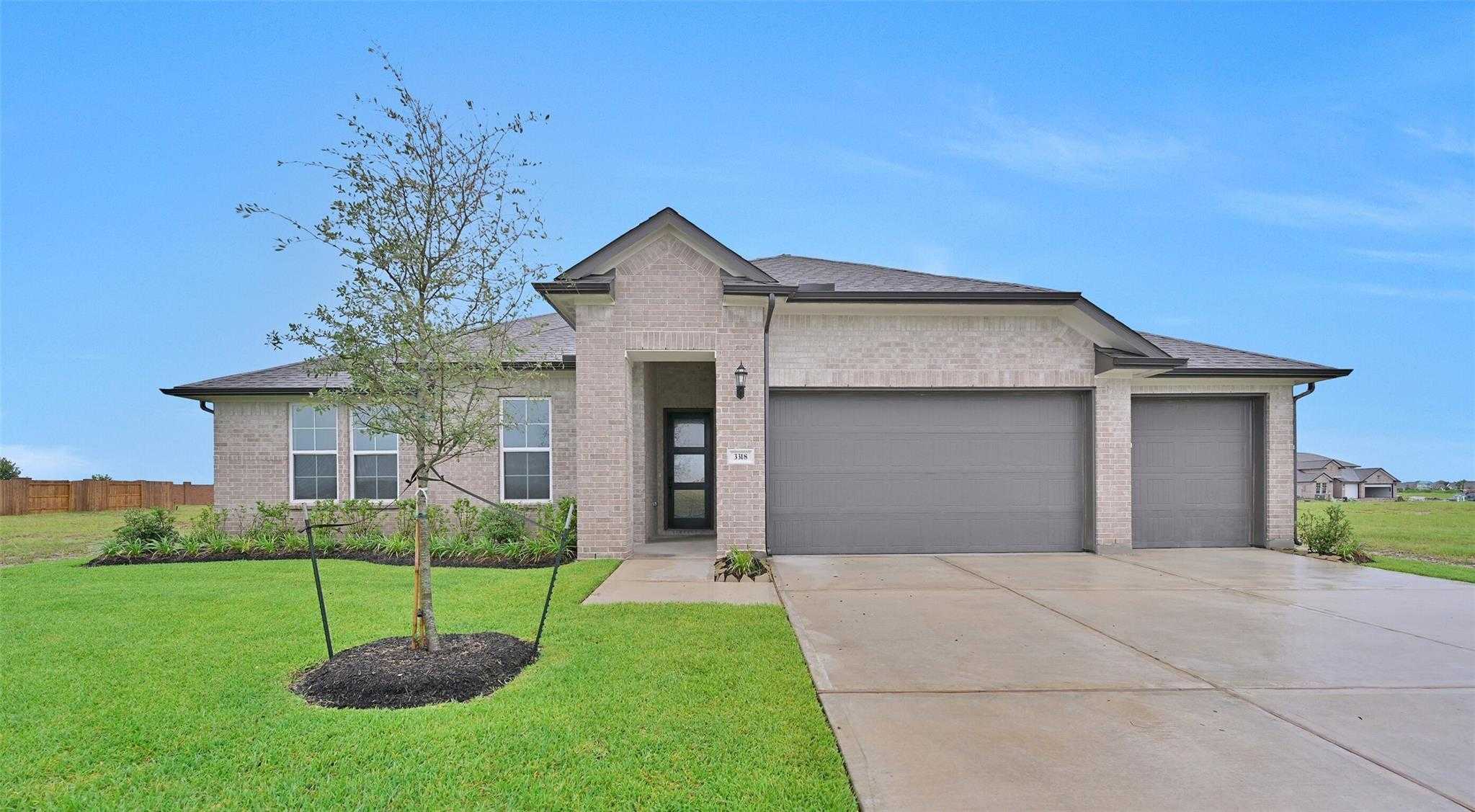 Modern brick single-story home with 3-car garage, front entry, and landscaped yard in Lago Mar, Texas City, Texas