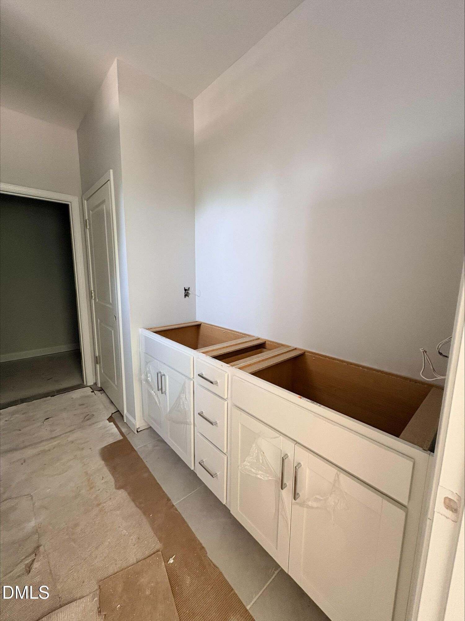 White double bathroom vanity cabinet base in The Daphne D floor plan at Woodland Crossing, Zebulon, North Carolina.