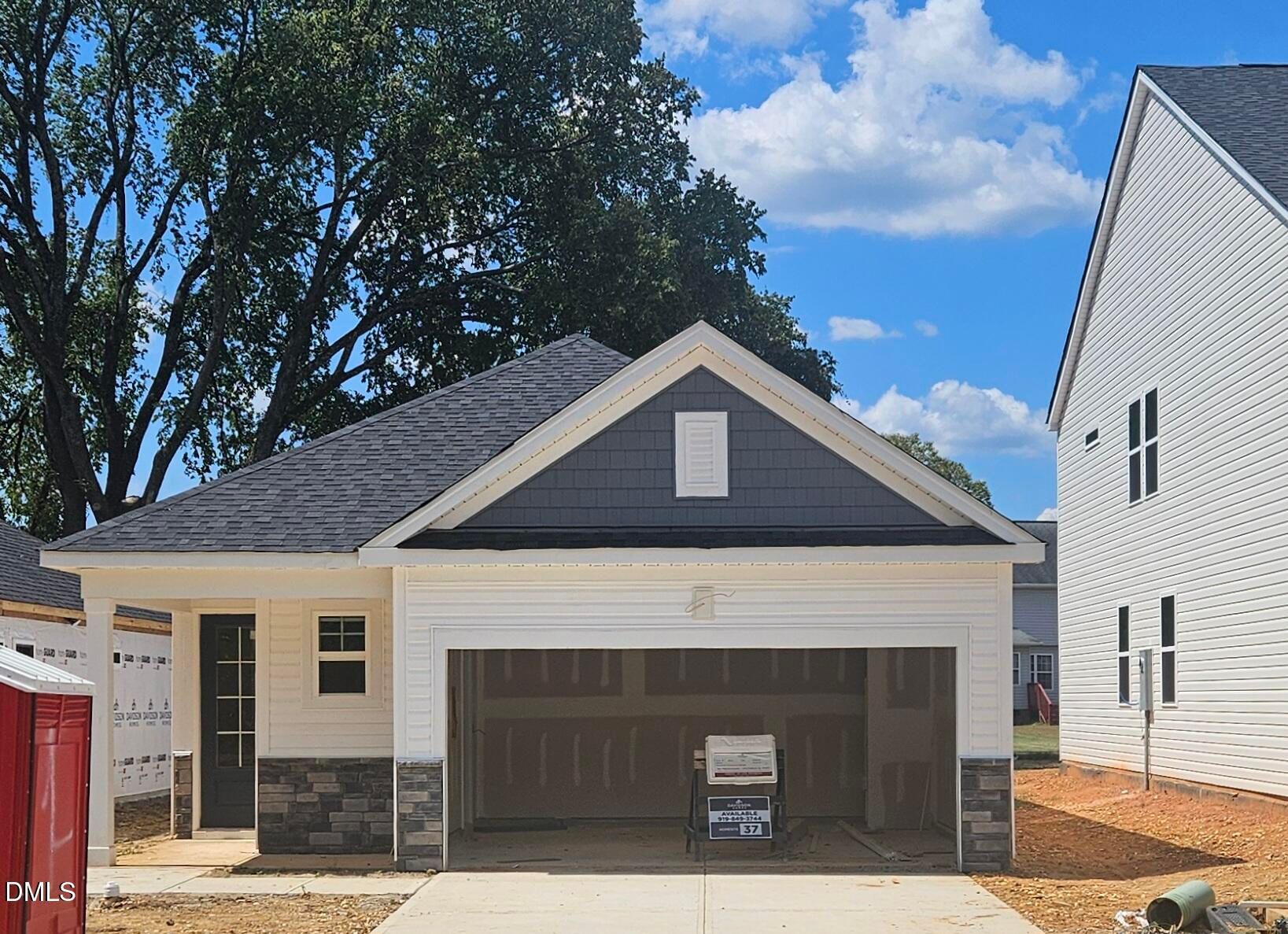 Front exterior of The Carter A by Davidson Homes with 2-car garage in Gregory Village, Lillington, North Carolina