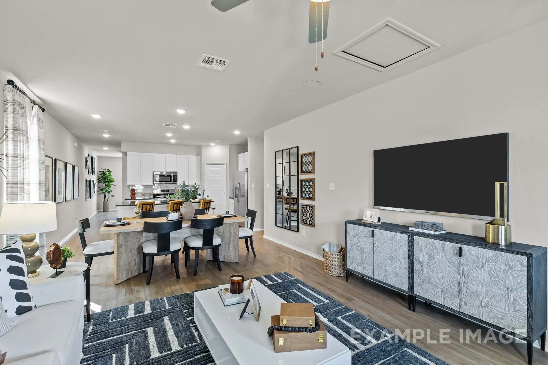 Open-concept living and dining area in The Sabine H floor plan by Davidson Homes in Heartland, Texas.