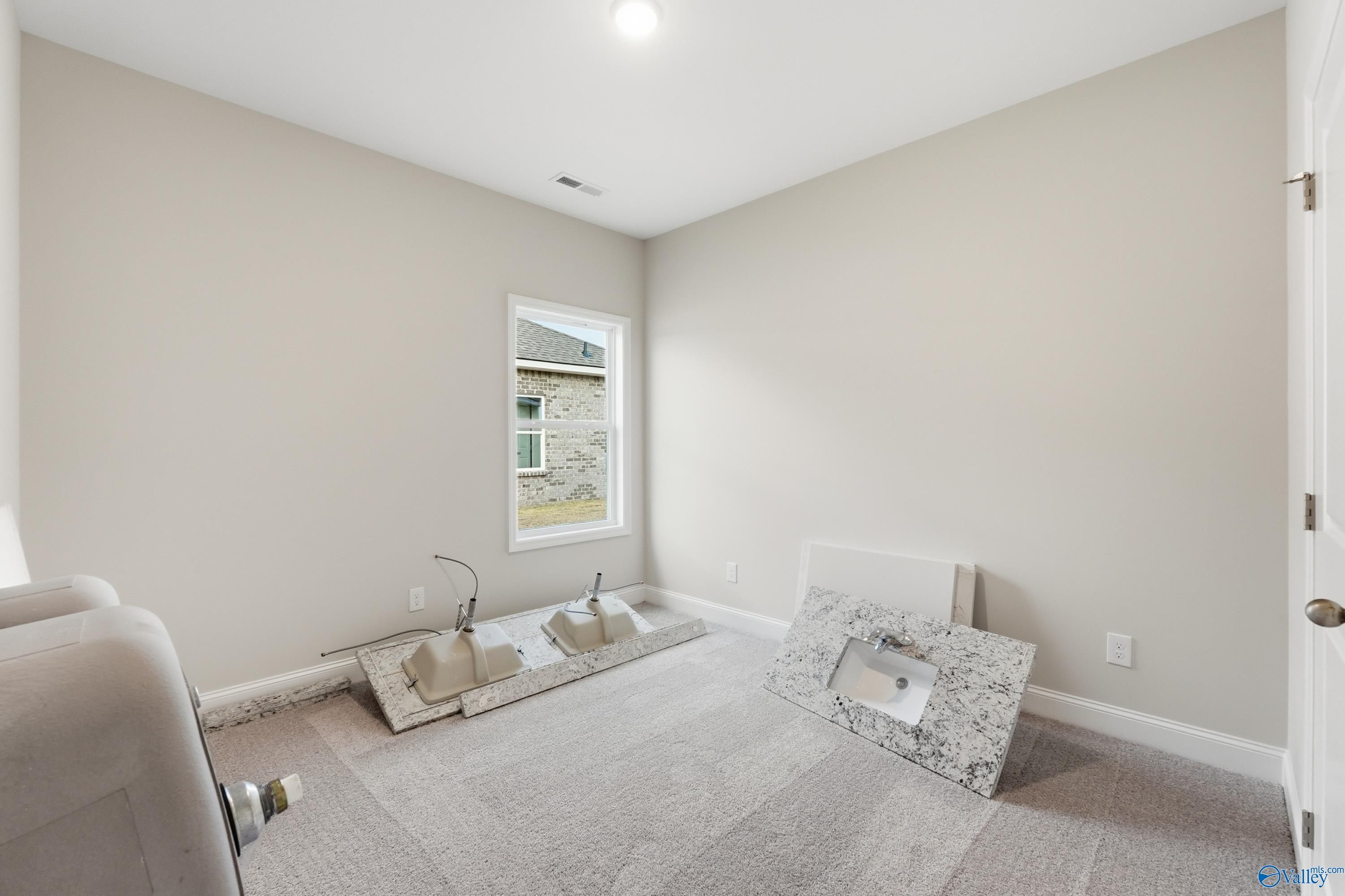Contemporary double vanity with white quartz countertop in secondary bath, The Asheville plan by Davidson Homes, Toney AL