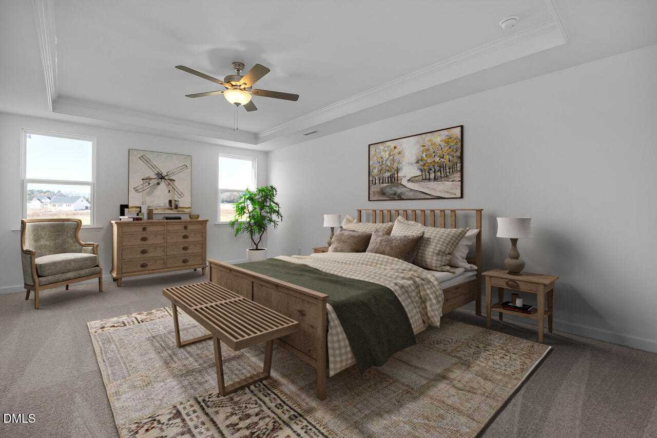 Serene master bedroom with king bed, wooden furniture, ceiling fan, artwork, and large windows in Davidson Homes The Cypress B II, Angier NC