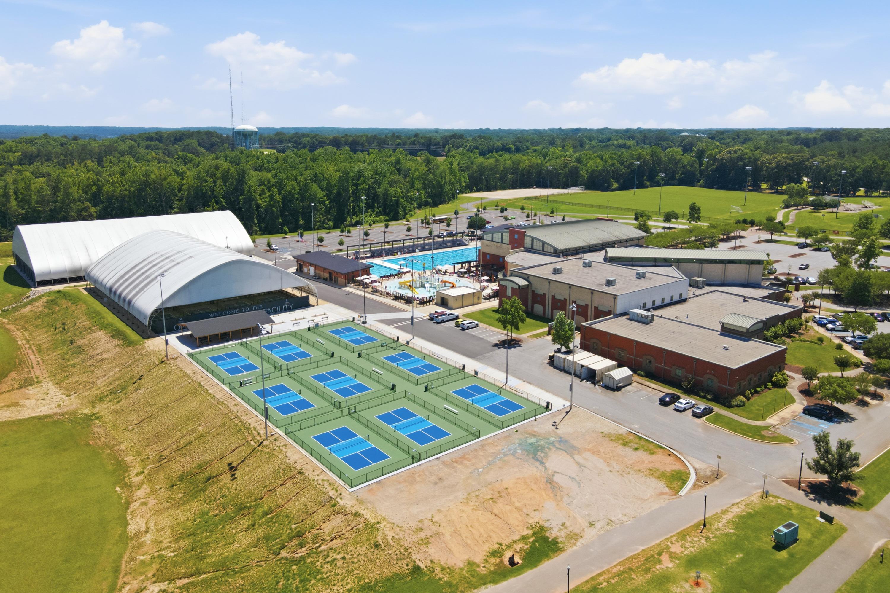 Aerial view of tennis courts, swimming pool, and sports complex at Anderson Lakes in Opelika, AL by Davidson Homes.