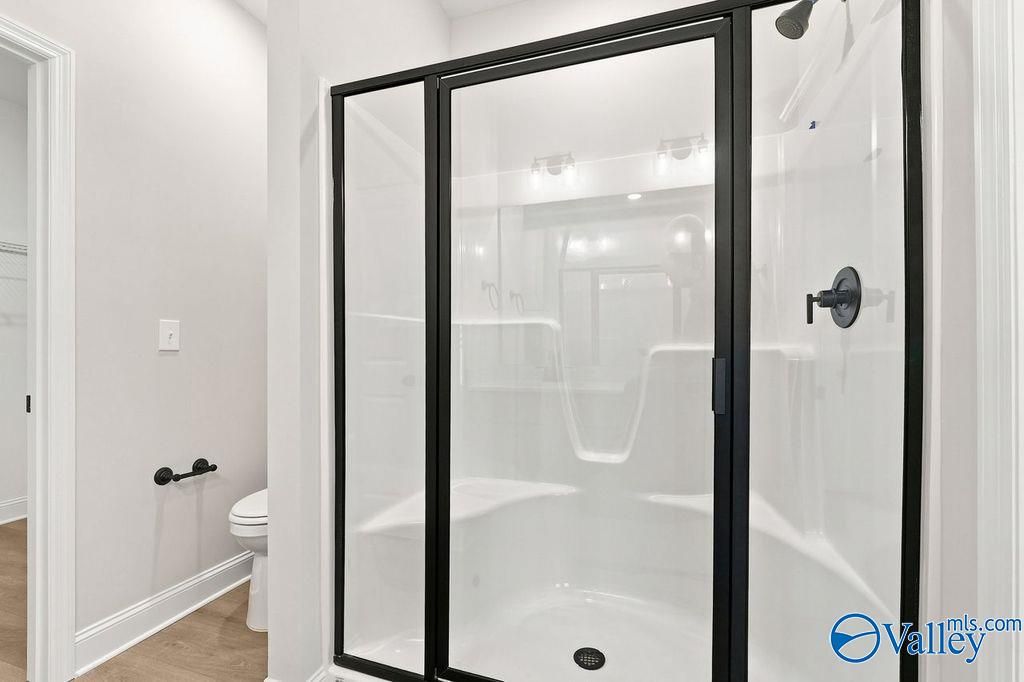 Modern walk-in shower with black frame in The Camilla C floor plan at The Retreat at Cain Park, Hartselle, Alabama.