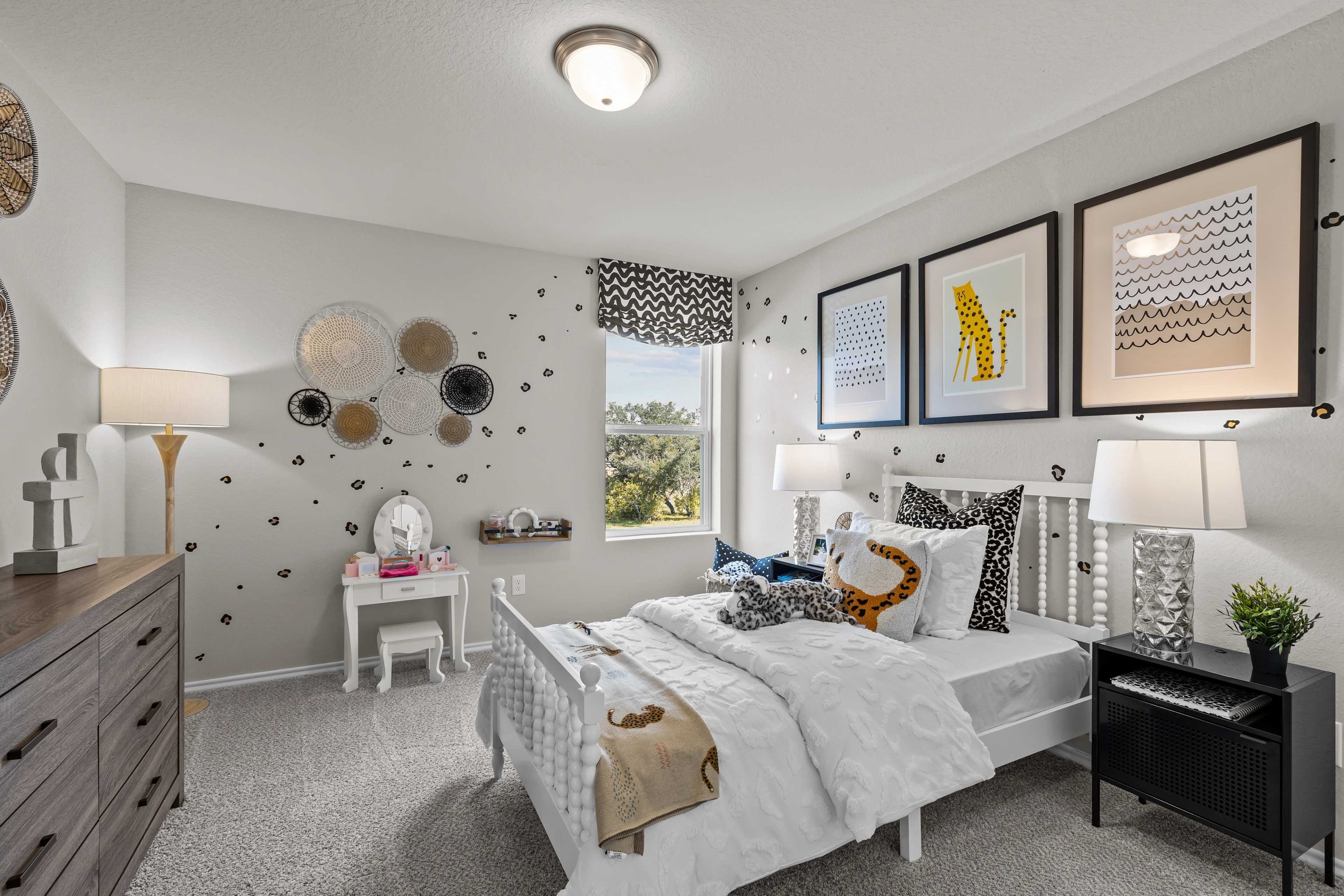 Charming girl's bedroom at Applewhite Meadows in San Antonio TX with twin bed, vanity, leopard accents and woven wall art
