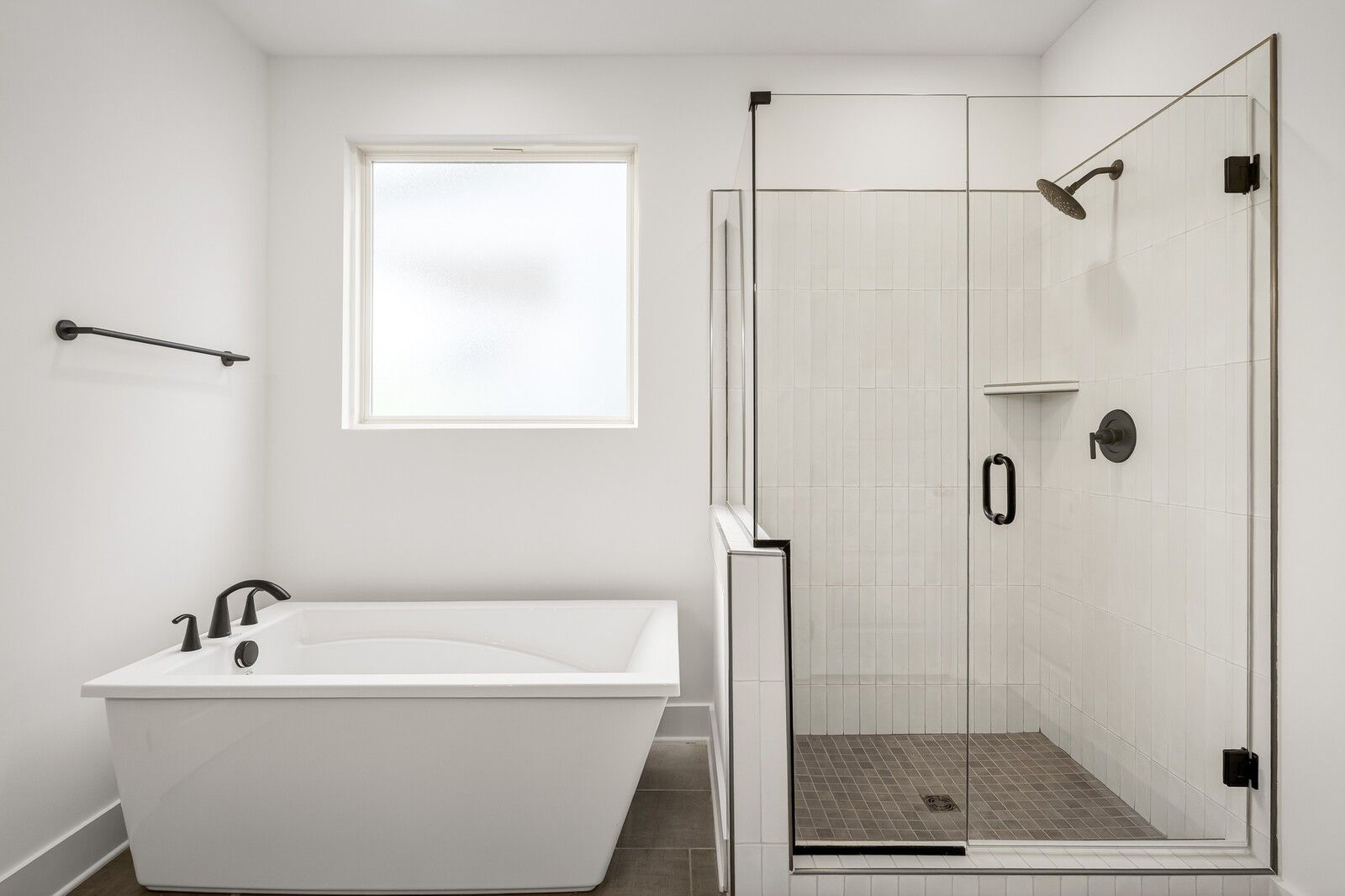 Modern master bathroom with freestanding tub and frameless glass shower in Davidson Homes The Ridgeport C, Gallatin, TN