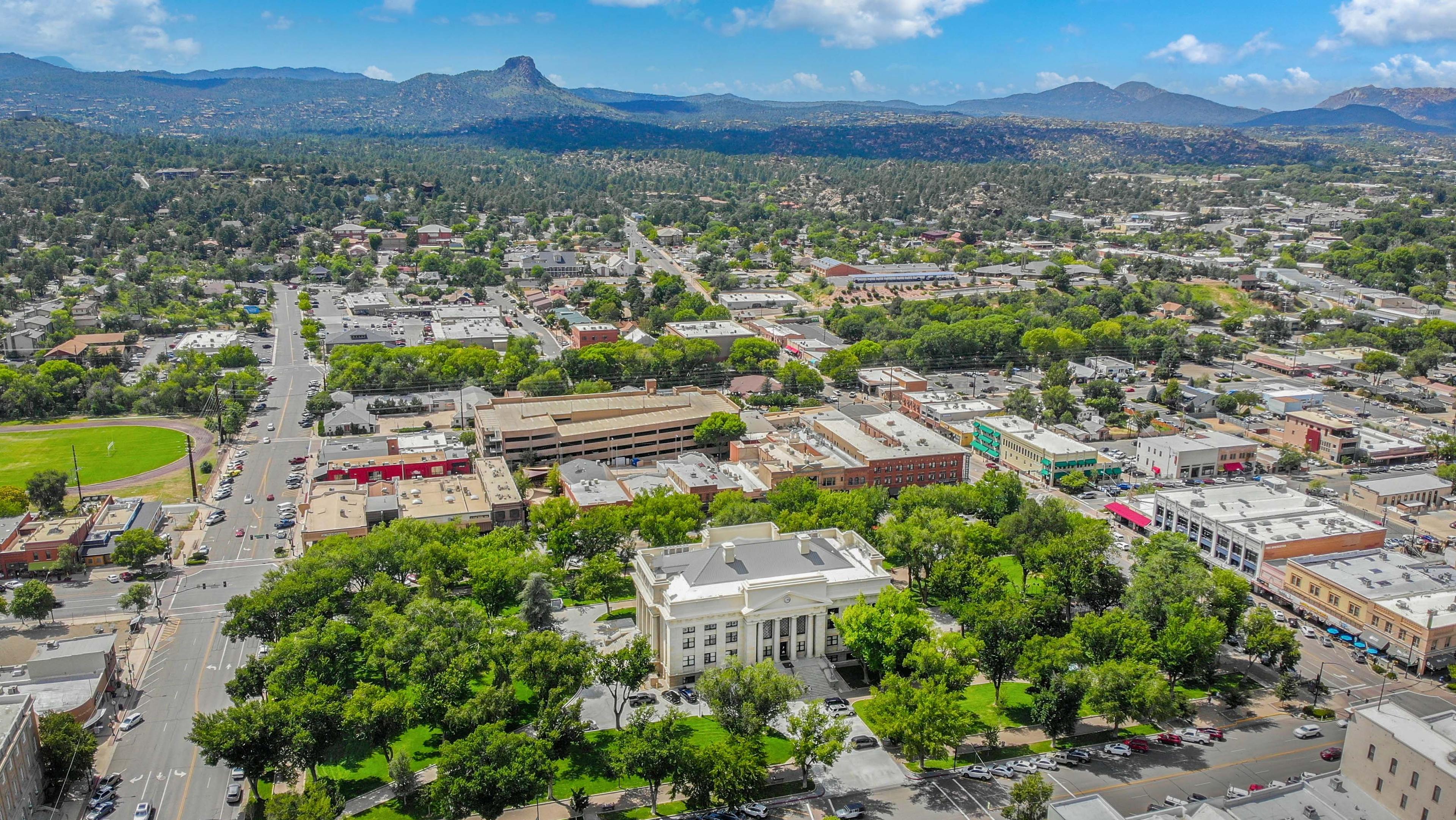 Arial view of Prescott, AZ showing downtown and mountain views.