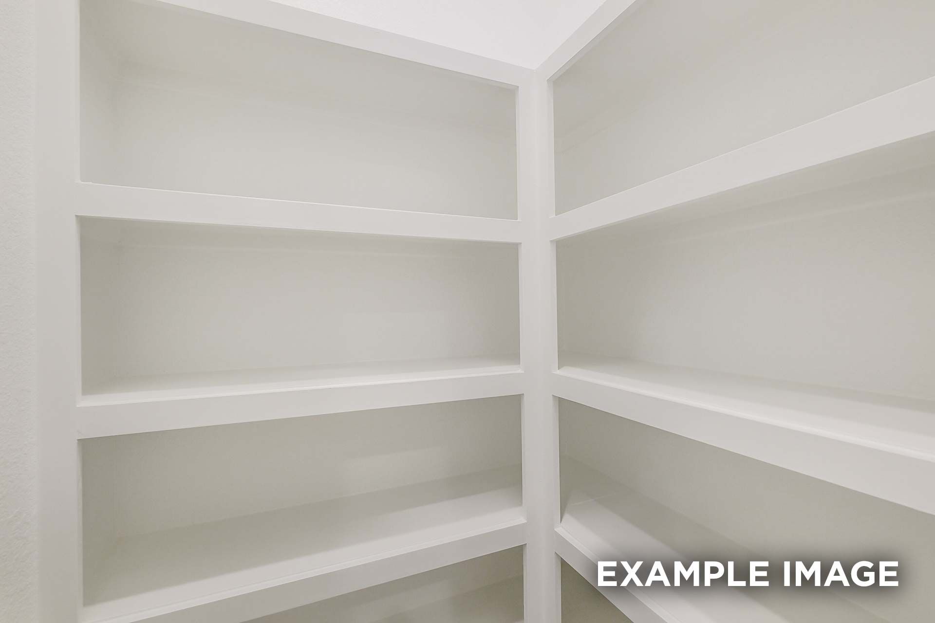 Spacious white built-in corner shelving in The Luna K walk-in closet by Davidson Homes