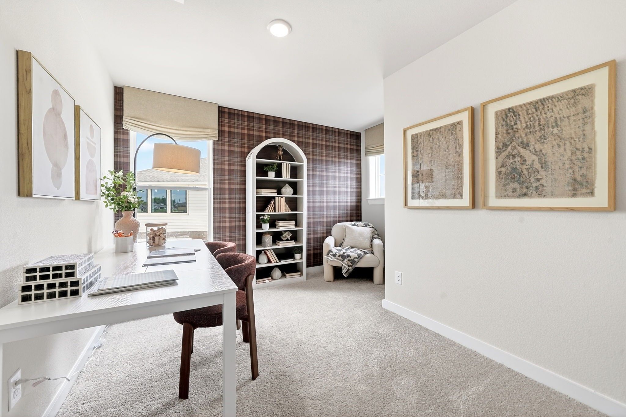 Cozy home office with plaid accent wall, desk, and arched bookshelf in The Sabine J floor plan by Davidson Homes, Heartland.