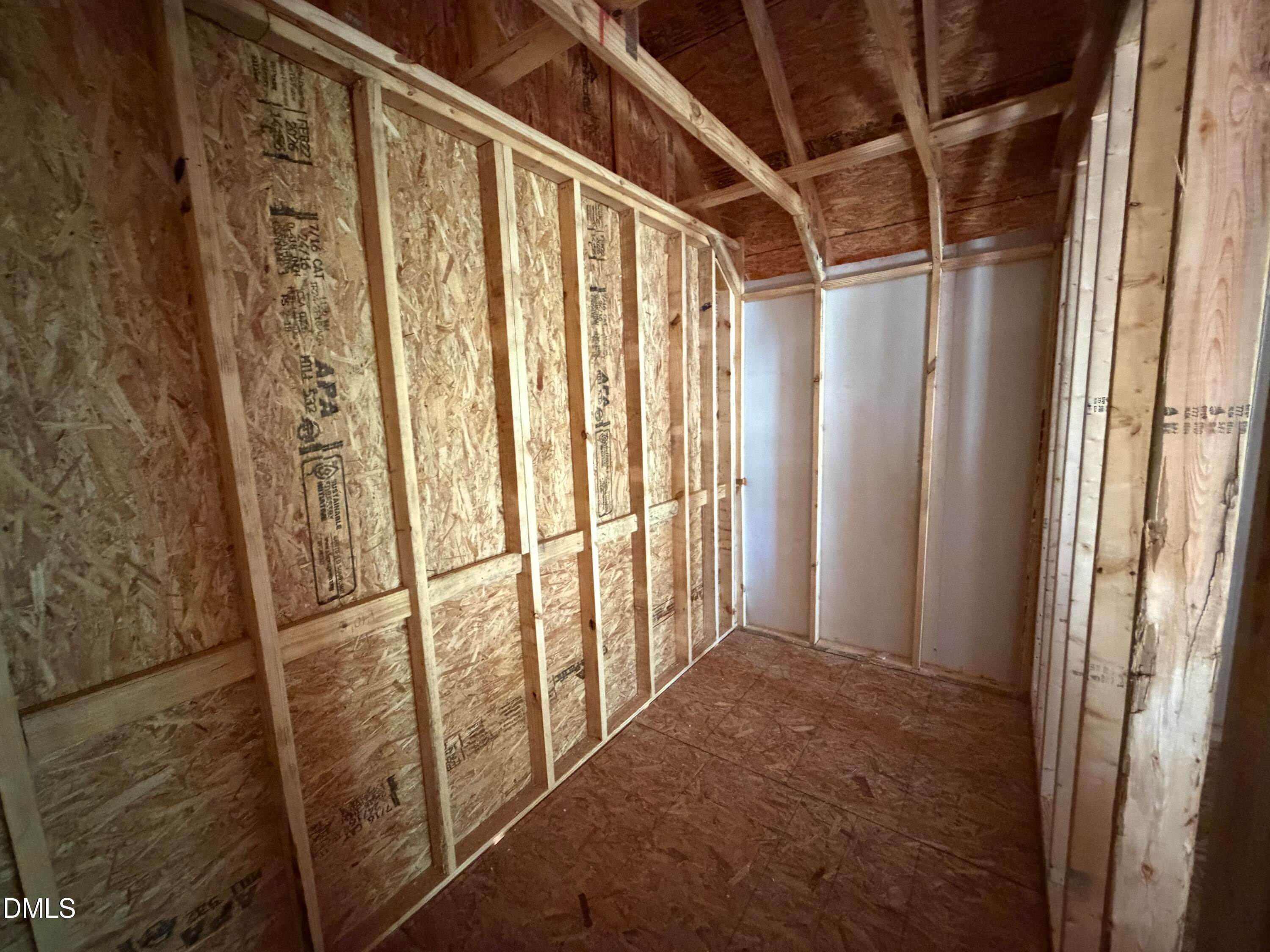 Exposed wooden framing and plywood walls in unfinished interior room of The Hickory II C 4-bedroom home, Lillington, NC