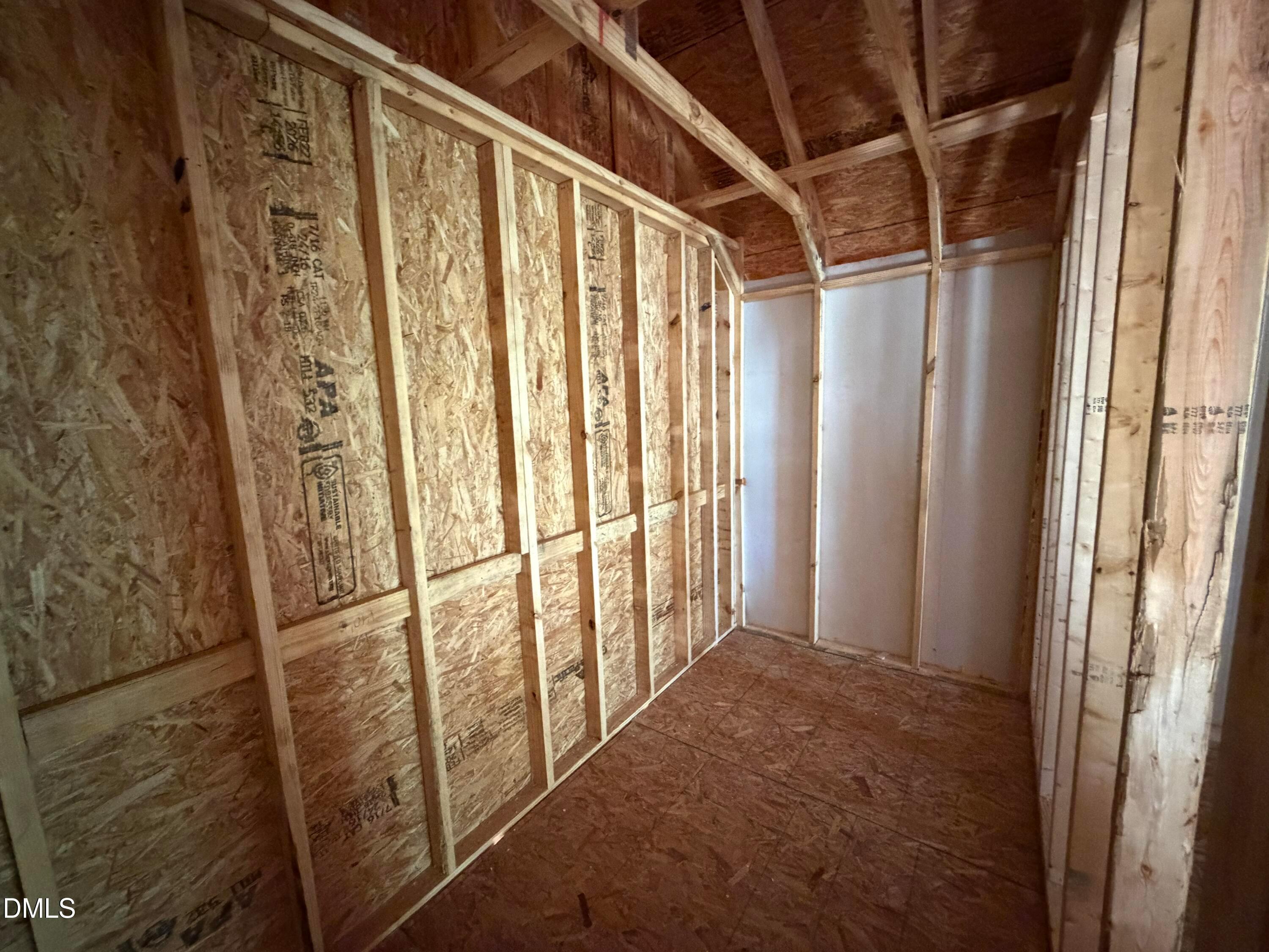 Exposed wooden framing and plywood walls in unfinished interior room of The Hickory II C 4-bedroom home, Lillington, NC