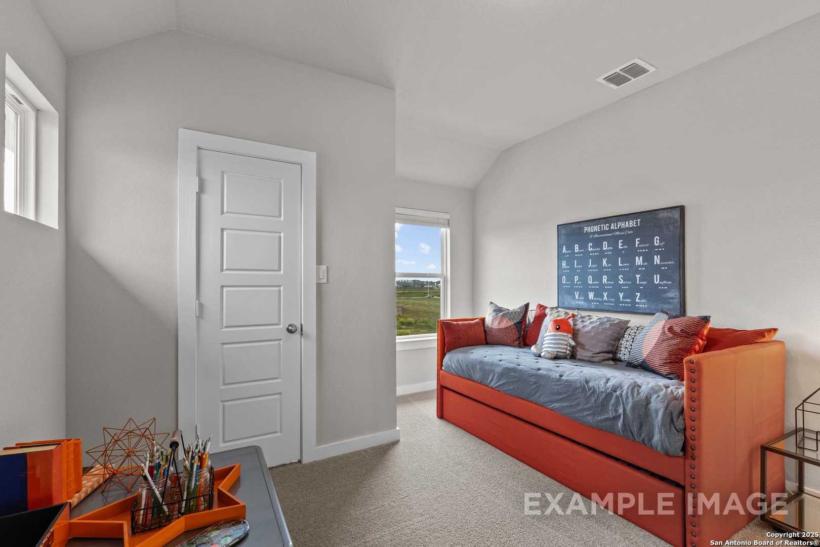 Cozy secondary bedroom with orange daybed, periodic table art, and window view in Davidson Homes Collin B, Seguin, Texas