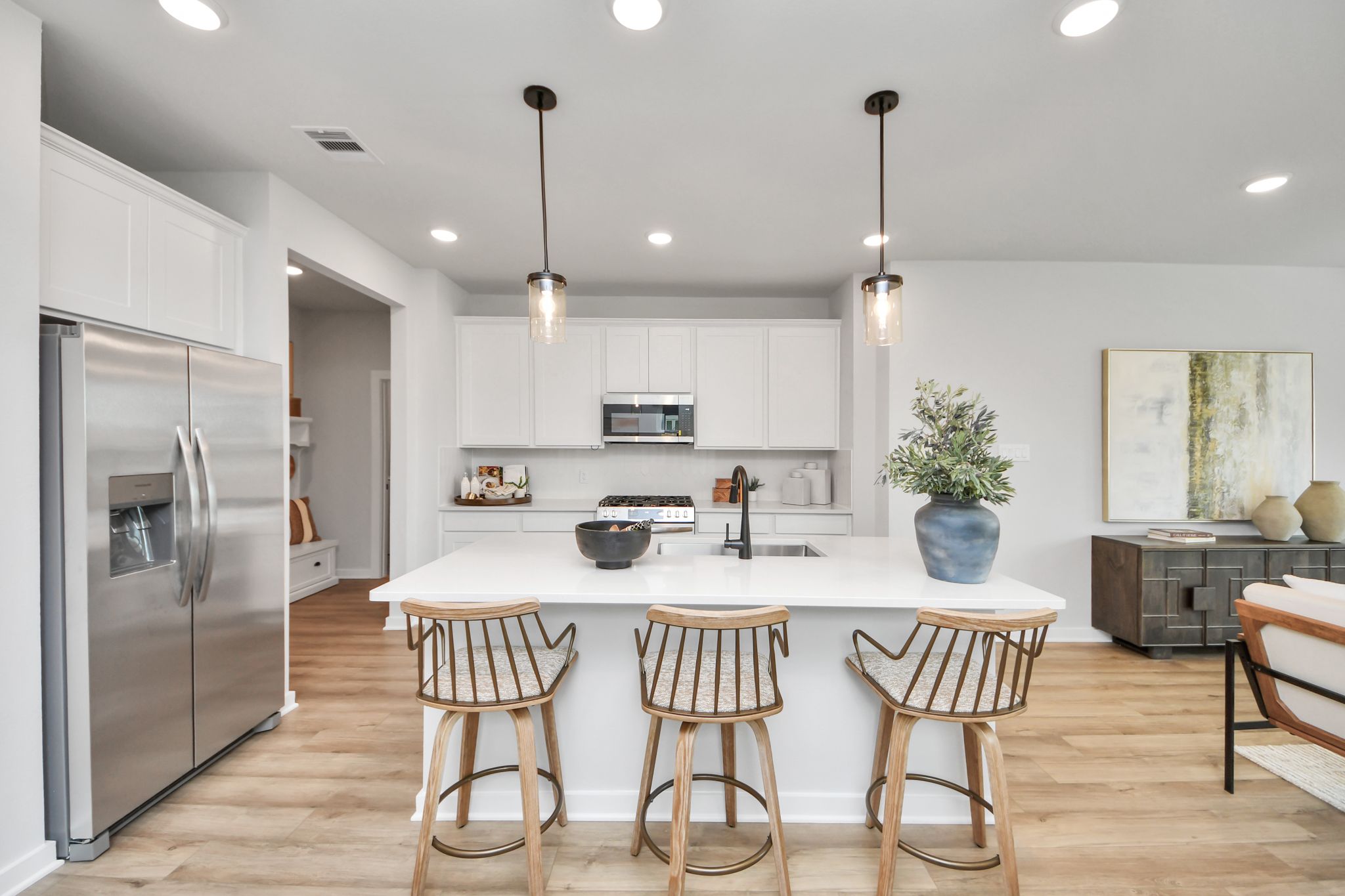 Modern kitchen with white cabinetry, stainless steel appliances, and a central island at Robins Landing in Houston, TX.