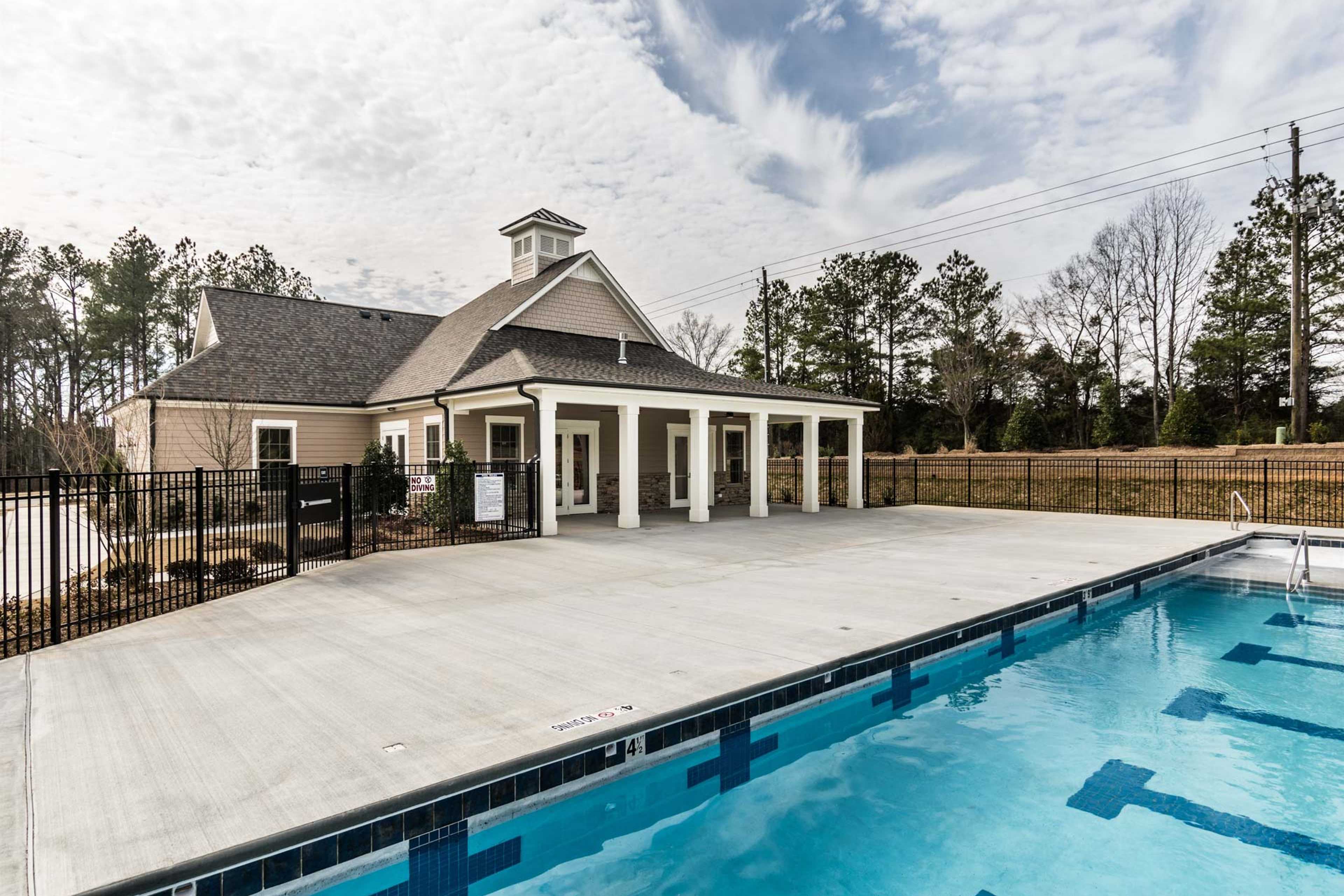 Resort-style swimming pool and clubhouse at Glenmere in Knightdale NC with covered porch, deck and lane markers