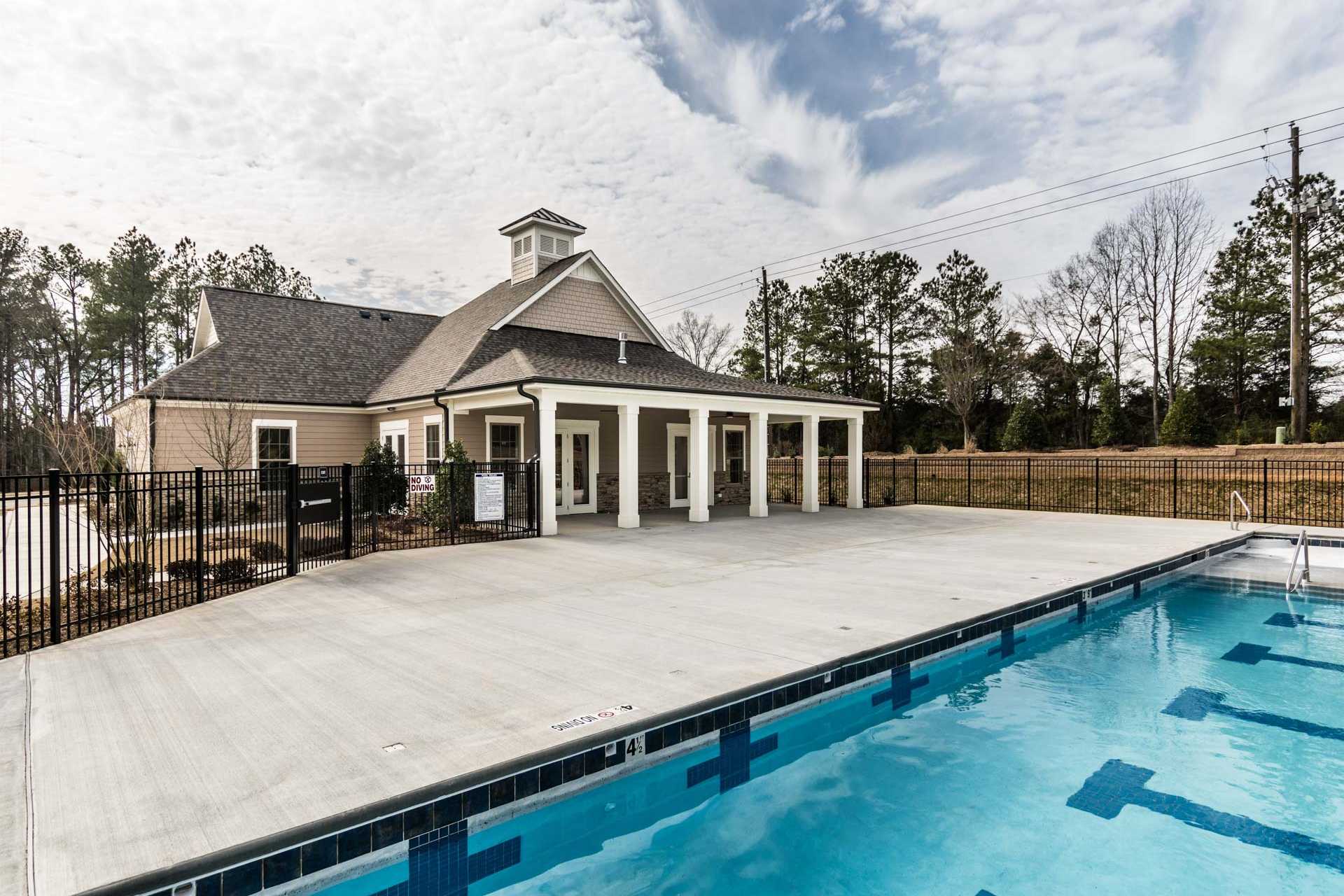 Resort-style swimming pool and clubhouse at Glenmere in Knightdale NC with covered porch, deck and lane markers