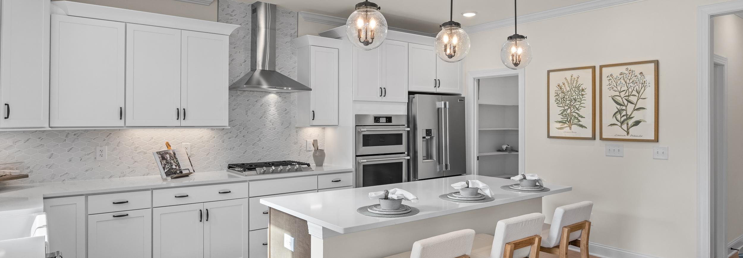 Modern white kitchen with island bar seating in Ashland, Apex NC by Davidson Homes, subway tile backsplash, hardwood floors