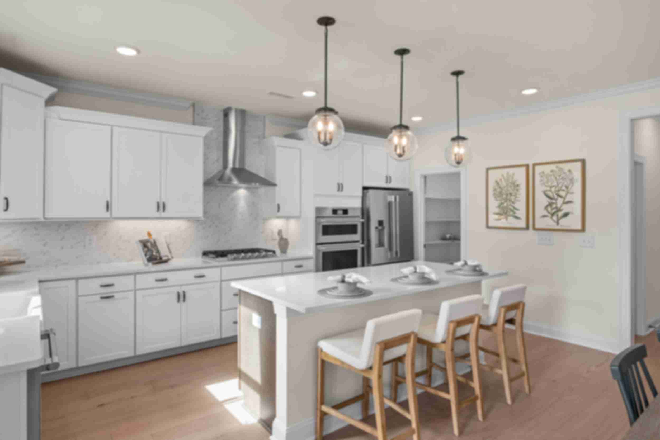 Spacious white shaker kitchen at Addison West in Holly Springs NC with quartz island, hardwood floors, and French doors