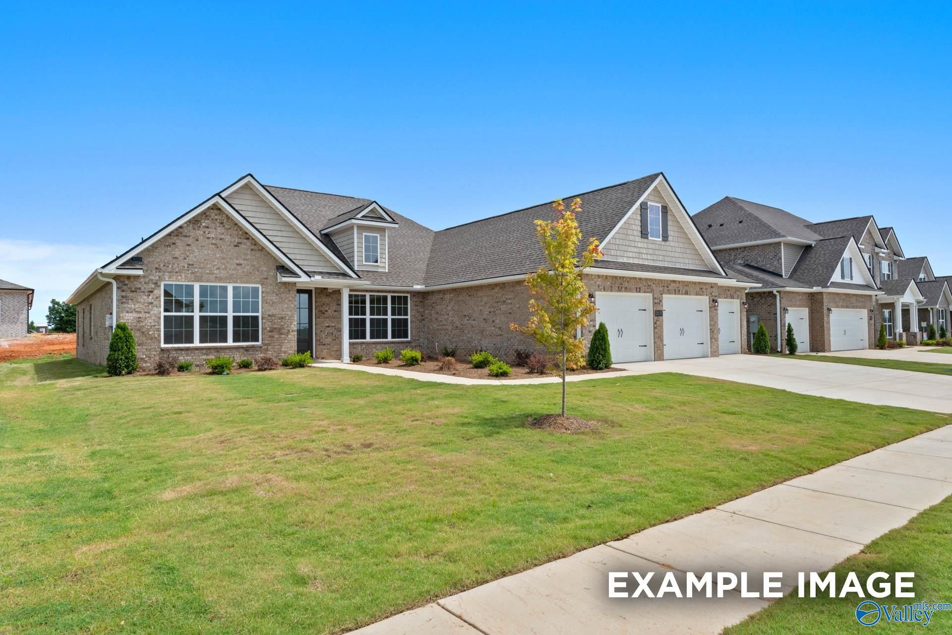 Modern brick 1-story home with 3-car garage, gabled roof, and landscaped front yard in Riverton Preserve, Huntsville, Alabama - Davidson Homes The Oxford