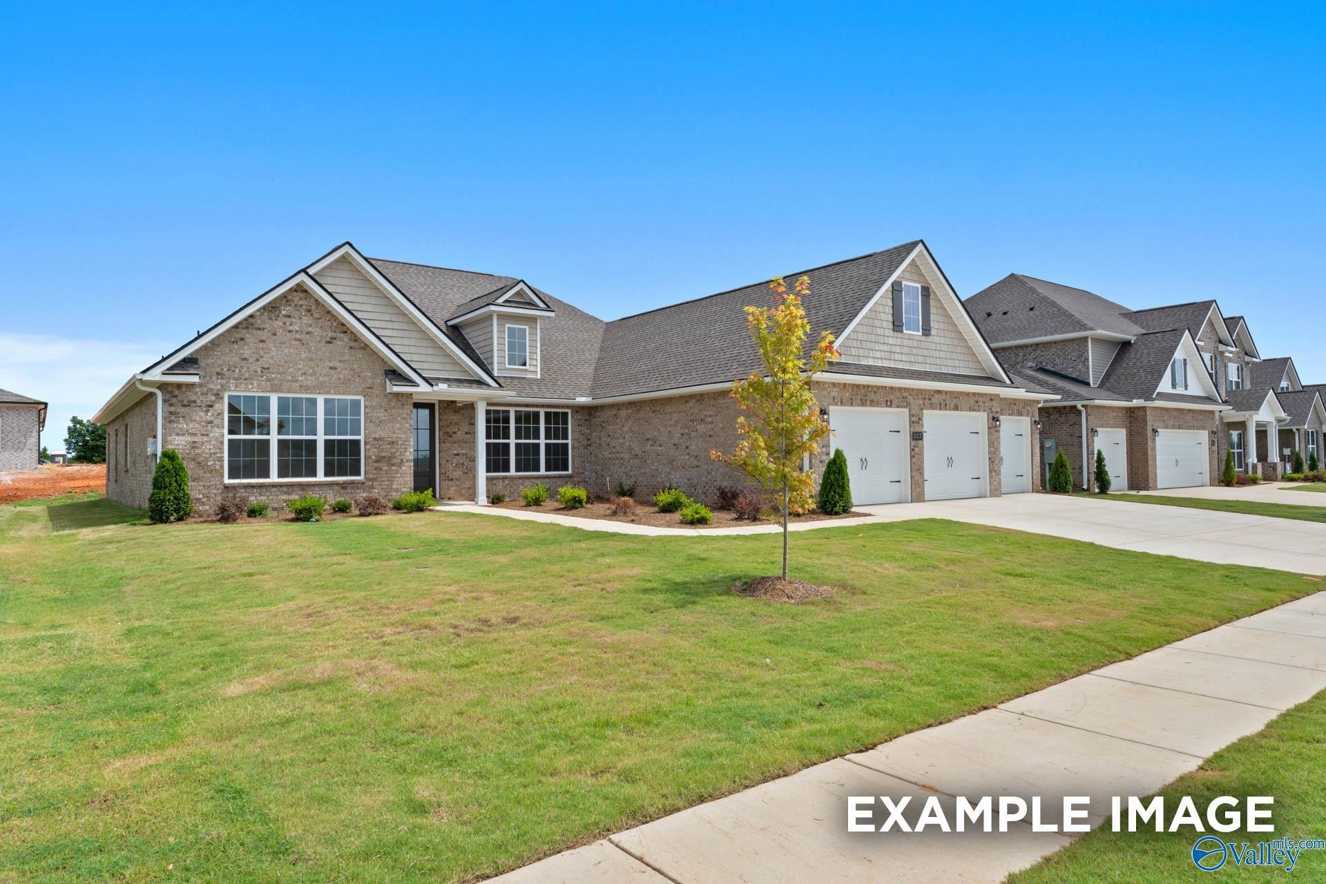 Modern single-story brick home with 3-car garage, landscaped yard in Riverton Preserve, Huntsville, AL by Davidson Homes