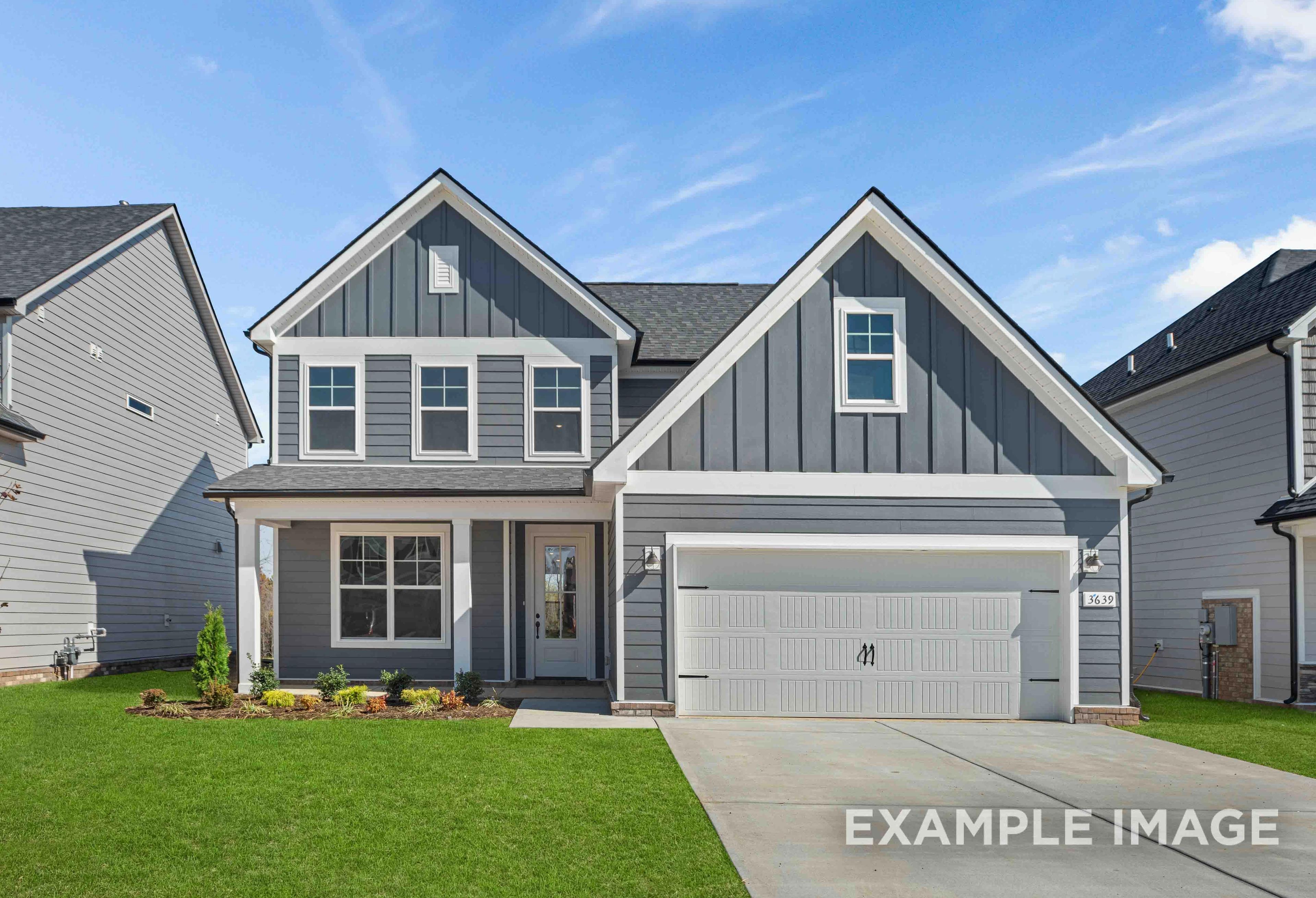 Modern two-story The Ash home elevation with gray siding, gabled roof, covered porch, and two-car garage in Mt. Juliet, TN