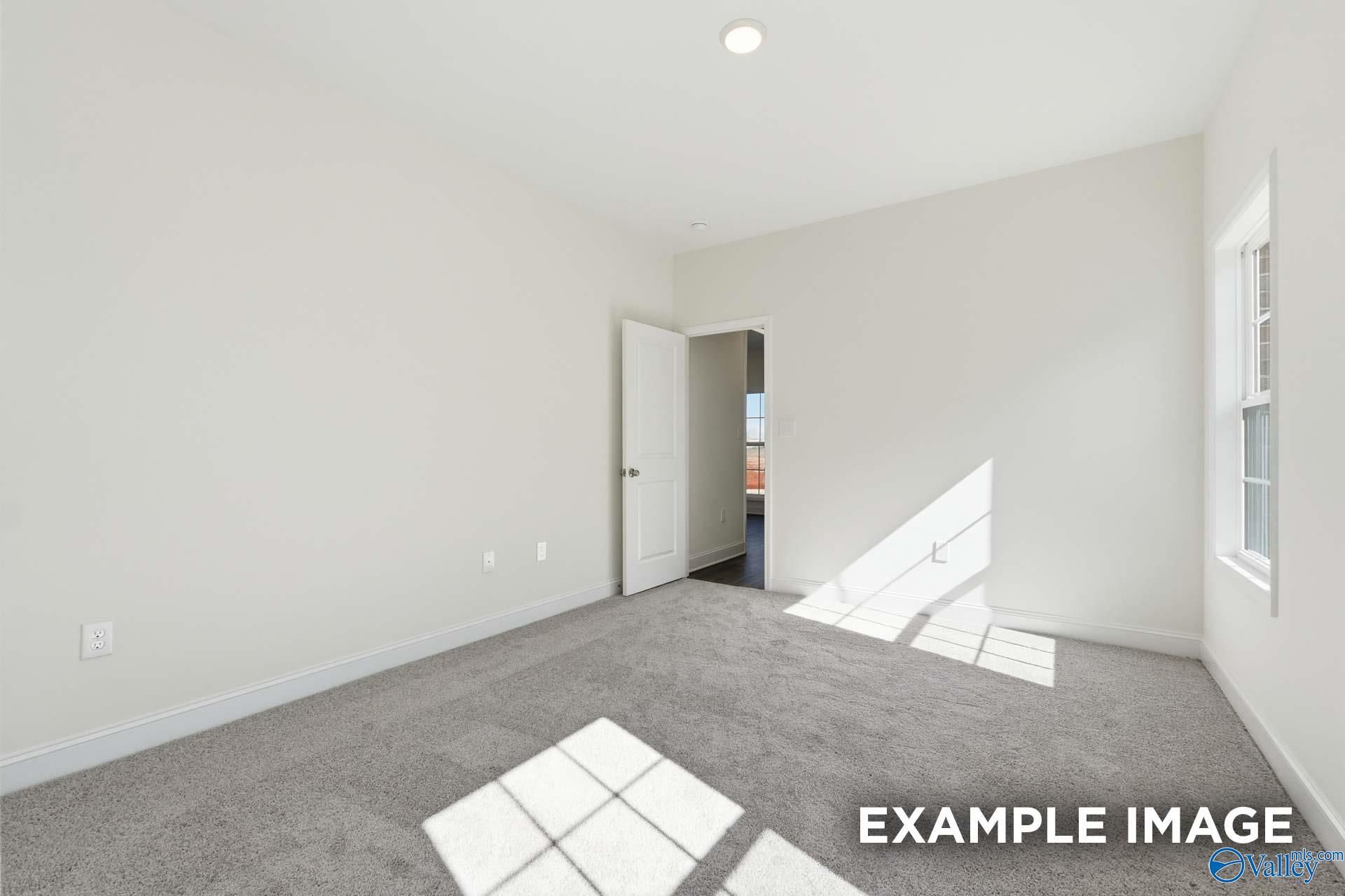 Bright, carpeted spare bedroom in The Valencia floor plan by Davidson Homes in Briercreek, Meridianville, Alabama.