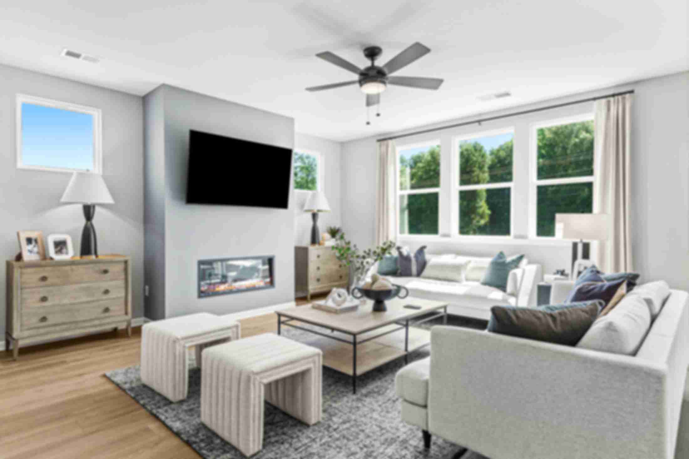 Open-concept kitchen dining living area in Fern Hollow Buford GA with white quartz island hardwood floors pendant lights