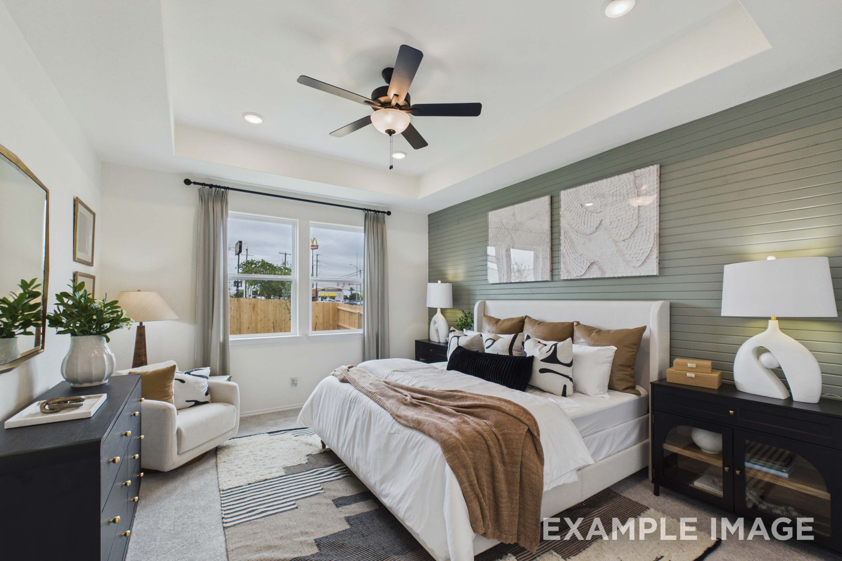Spacious master suite in The Laurel G featuring a tray ceiling, shiplap accent wall, and modern neutral decor.