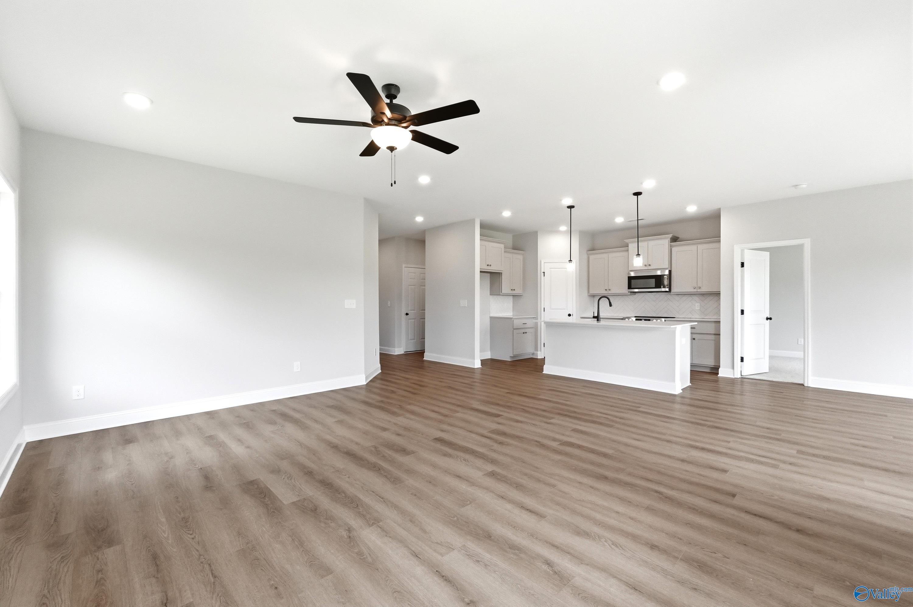 Open-concept living room and kitchen in The Franklin floor plan at Ricketts Farm, Athens, Alabama.