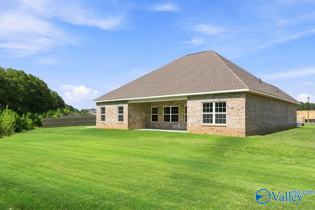 Brick single-story Davidson Homes Rockford plan with covered patio and fenced backyard in Cain Park, Hartselle, Alabama