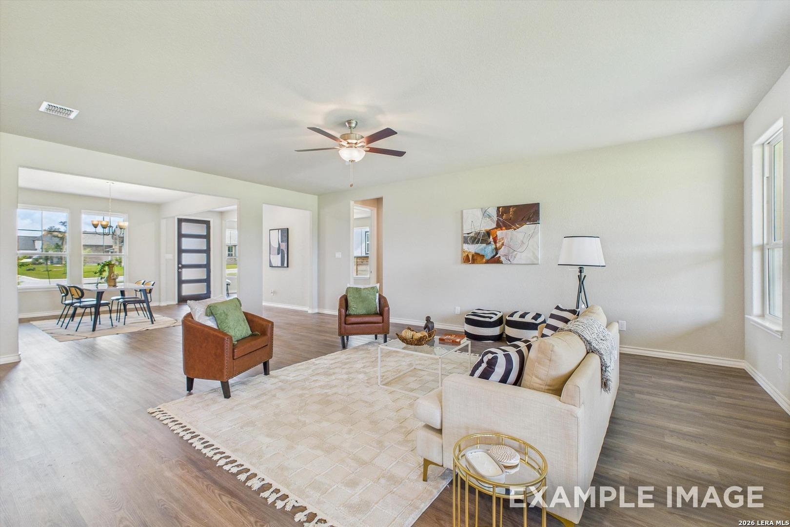 Open-concept living room with modern decor in The Foster F floor plan at Potranco Oaks, Castroville, Texas.