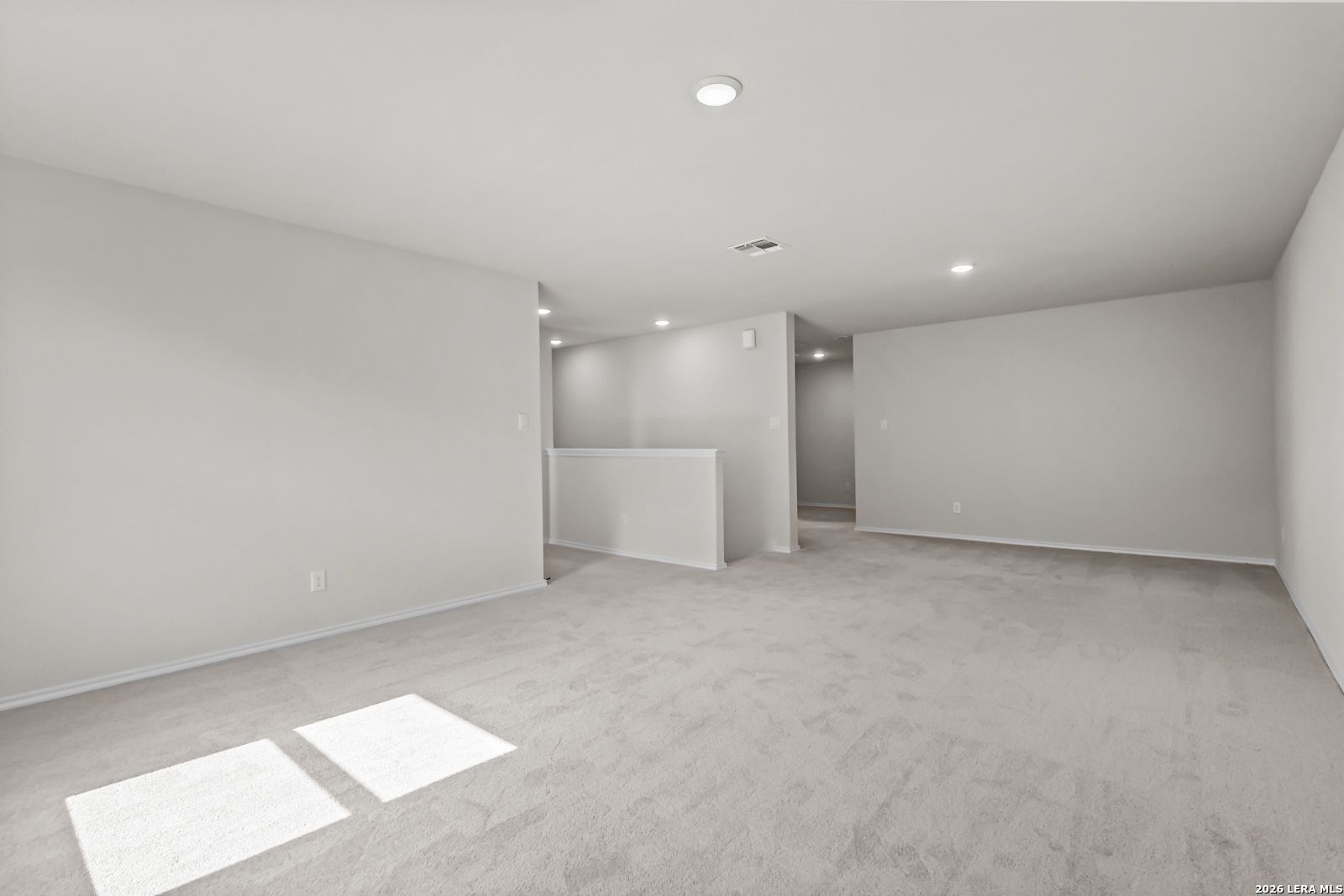 Spacious carpeted game room in The Douglas C floor plan by Davidson Homes at Hannah Heights in Seguin, Texas.