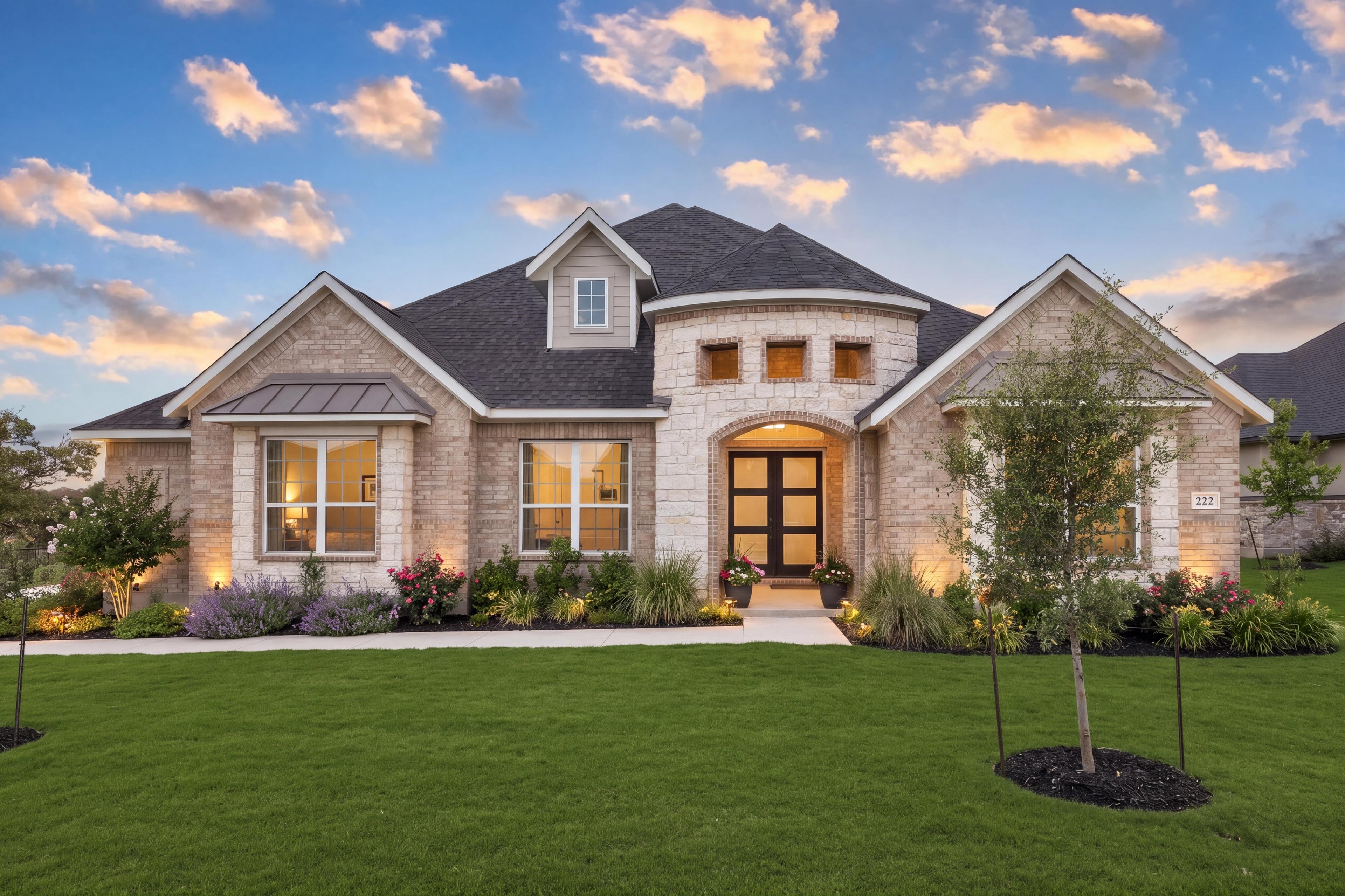 Light colored brick and stone 1-story home at Potranco Oaks in Castroville, TX