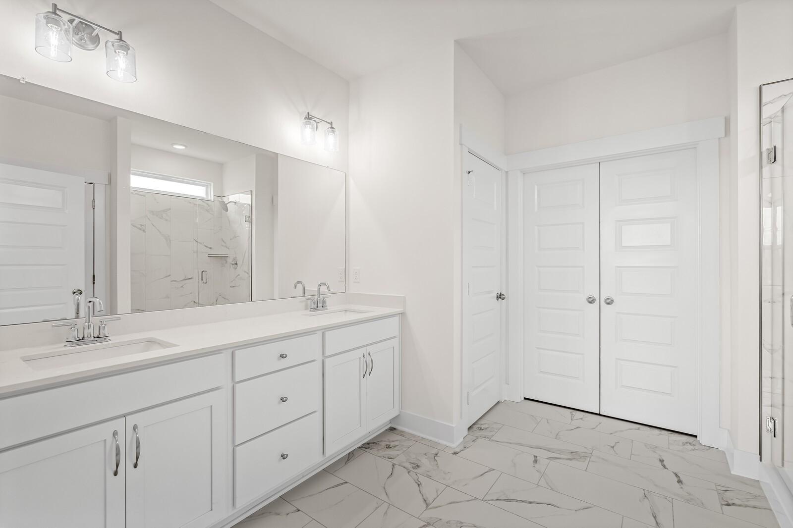 Modern bathroom with double vanity and white cabinets in The Ridgeport D floor plan by Davidson Homes, Mt. Juliet, TN.