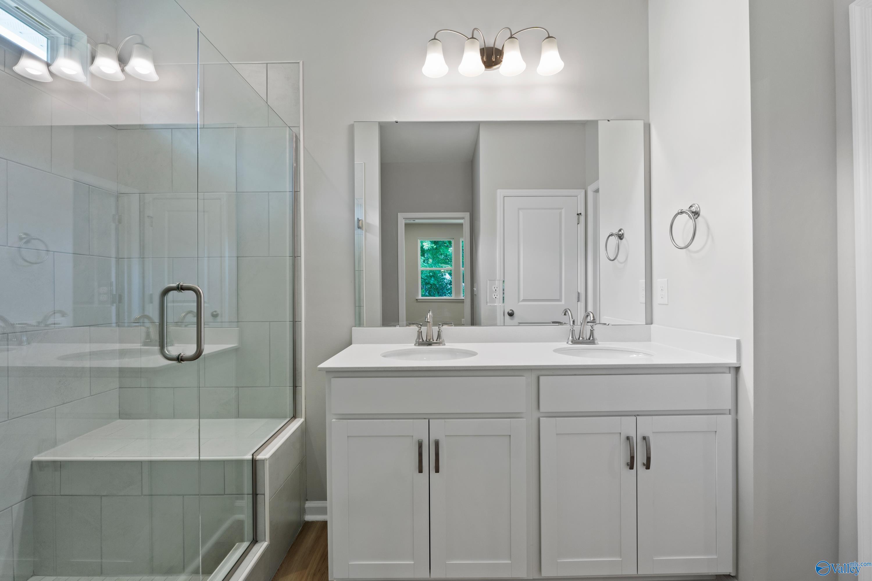 Modern master bathroom featuring frameless glass shower and double vanity in Davidson Homes The Polaris, Fayetteville, TN