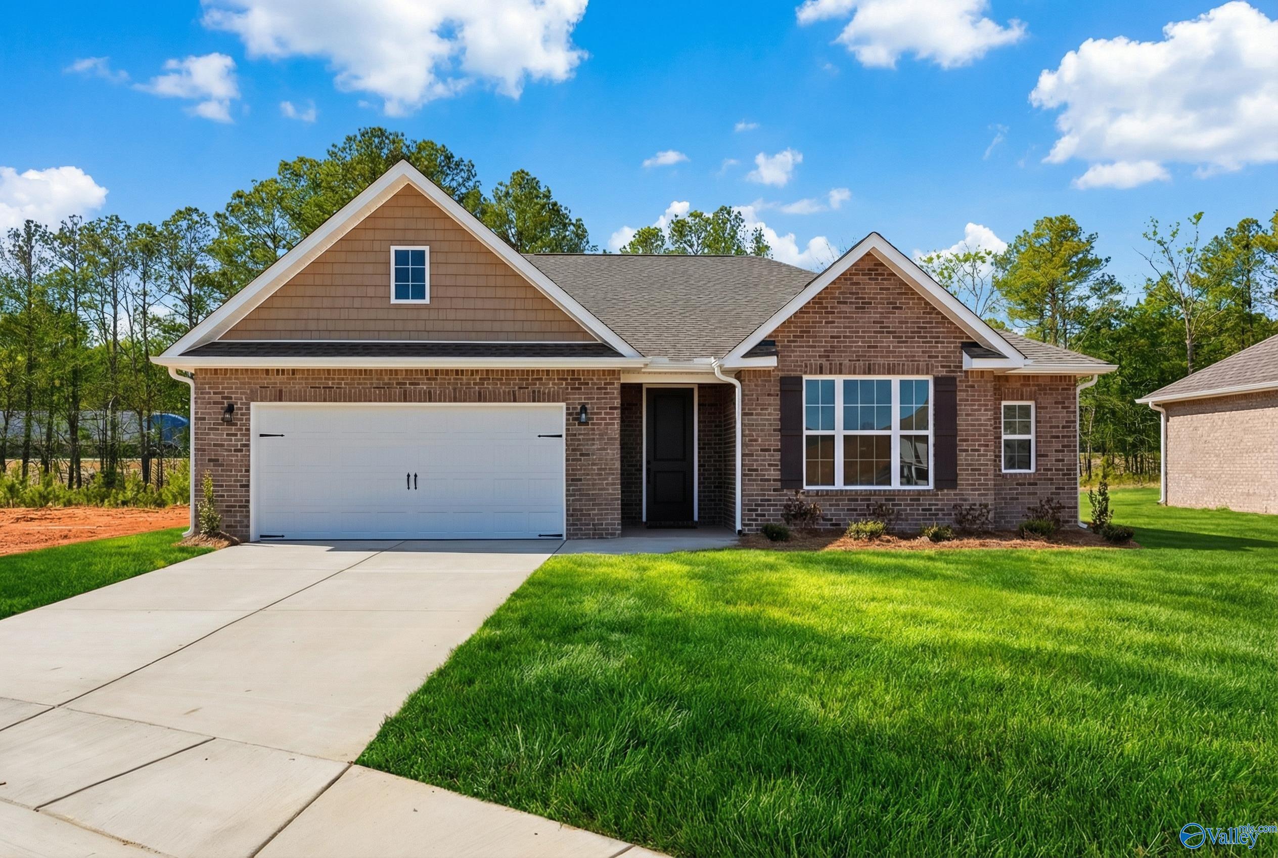 Modern 1-story brick home with 2-car garage and lush landscaping in Cain Park, Hartselle, Alabama - Davidson Homes Montgomery B