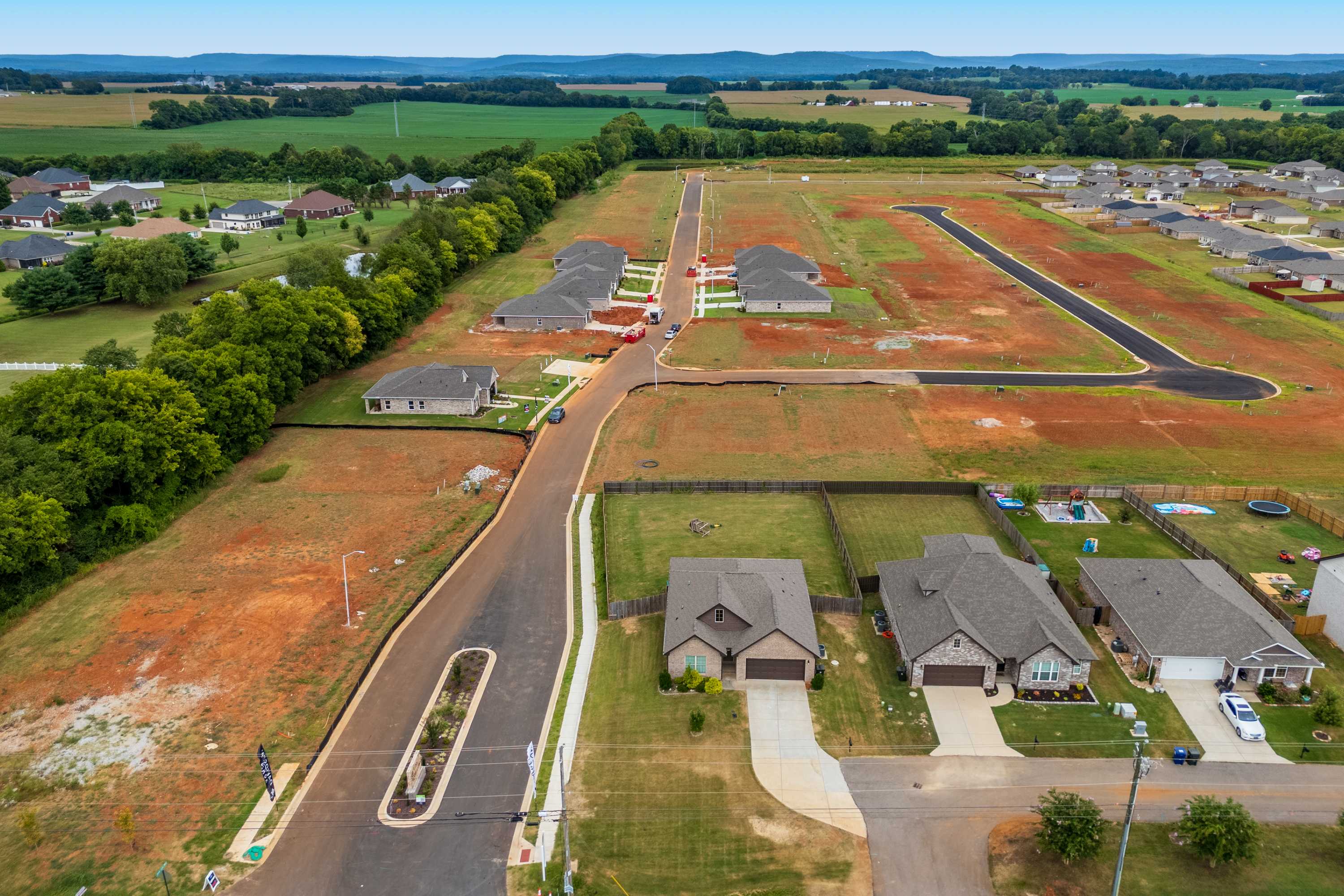 Aerial view of Lynn Meadows neighborhood in Meridianville Alabama featuring new single-family homes, construction sites, and surrounding farmlands
