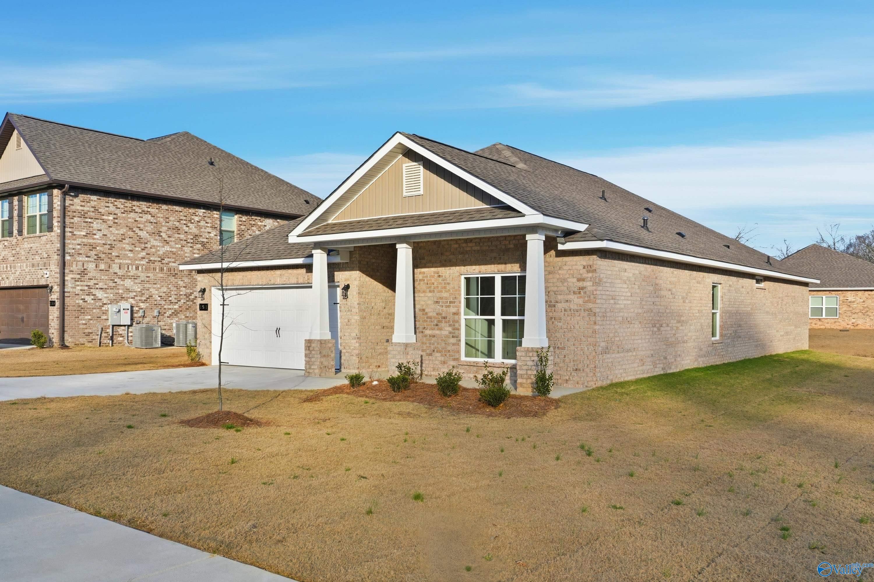 Modern 1-story brick home with 2-car garage, columned front porch, and landscaped yard in The Highlands, Arab, Alabama - Davidson Homes The Daphne D