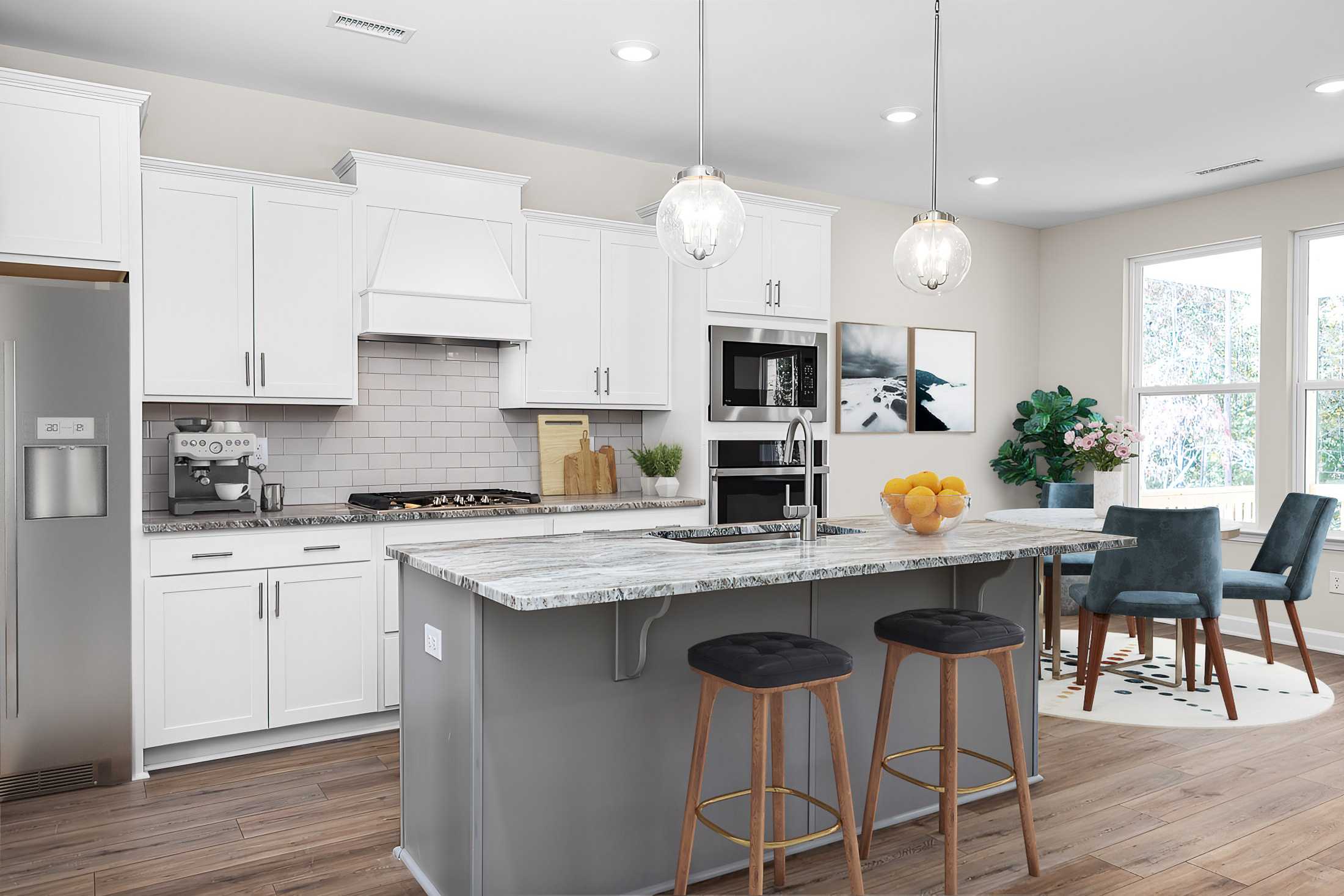 Modern white kitchen at Stagecoach Corner in Mebane NC by Davidson Homes with quartz island seating subway tile and hardwood floors