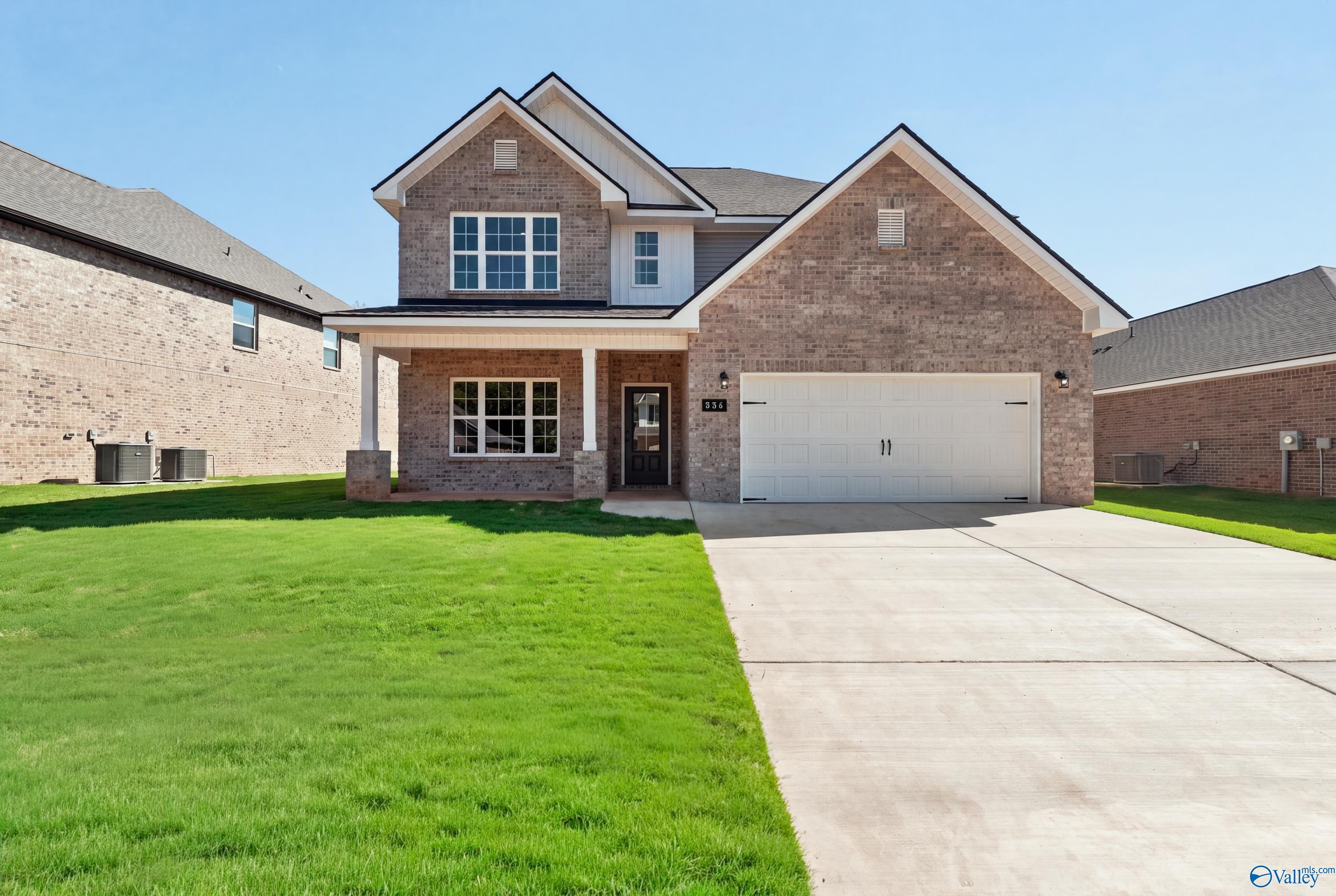 Brick 2-story home with covered porch and 2-car garage in Creek Grove, New Market, Alabama by Davidson Homes